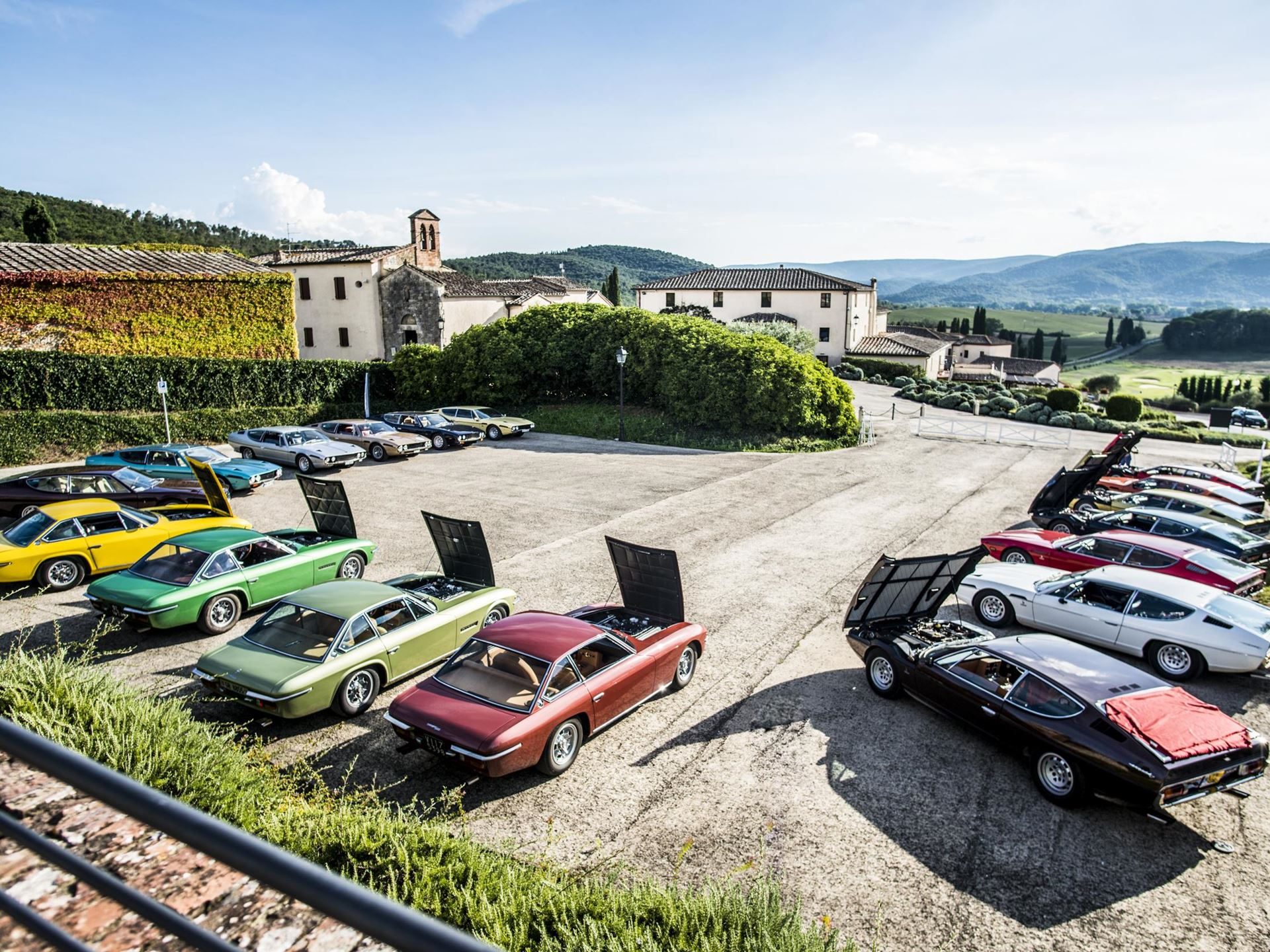 Ten Years Of Polo Storico: How Lamborghini Built The Only Heritage Program That Rebuilds Cars From The Dead 9 Collection of vintage lamborghini isleros, espadas, jaramas, and urracos parked outdoors with hoods open in an italian countryside setting