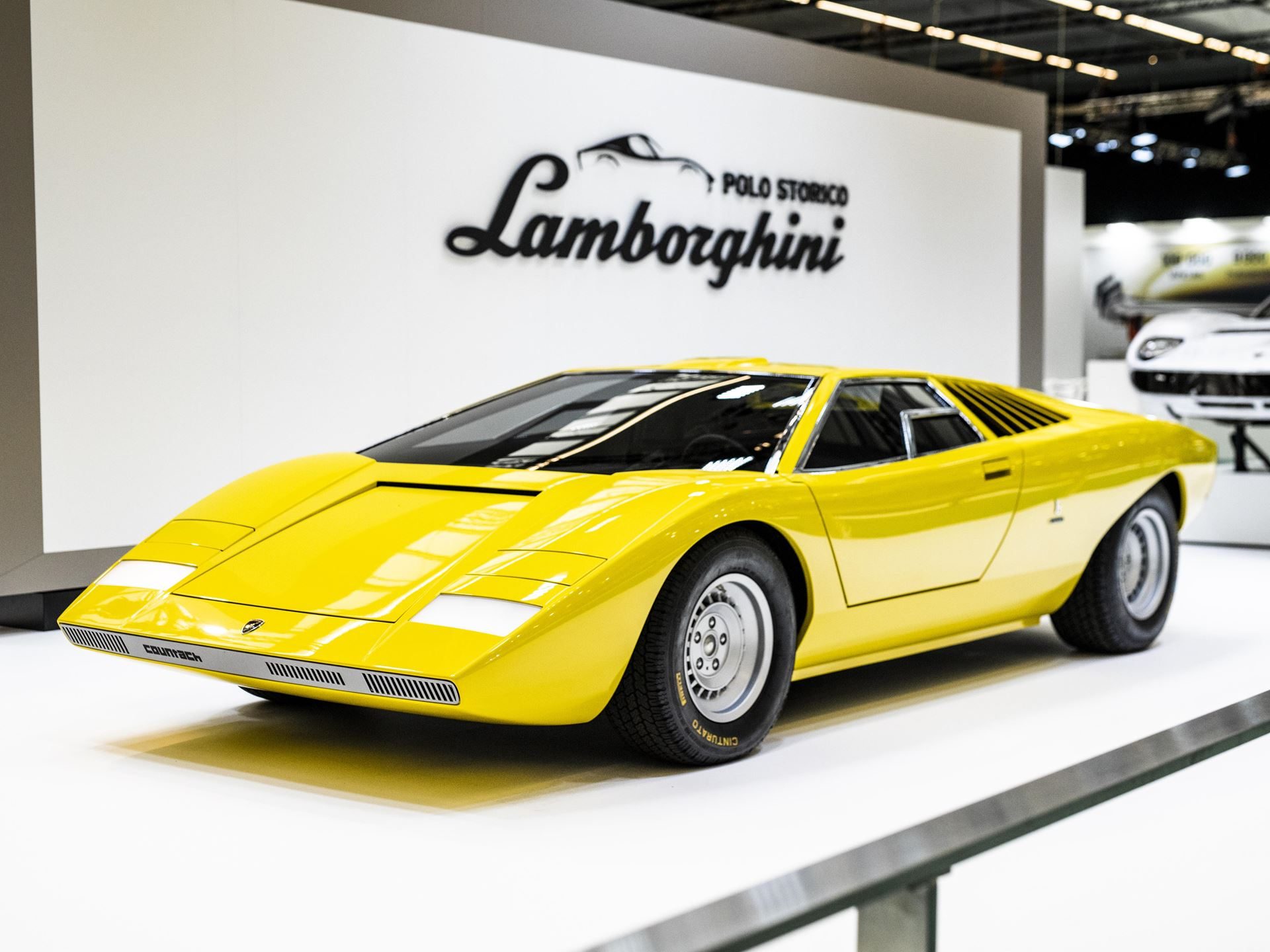 Ten Years Of Polo Storico: How Lamborghini Built The Only Heritage Program That Rebuilds Cars From The Dead 3 Yellow lamborghini countach lp500 prototype on a white exhibition stand with polo storico branding