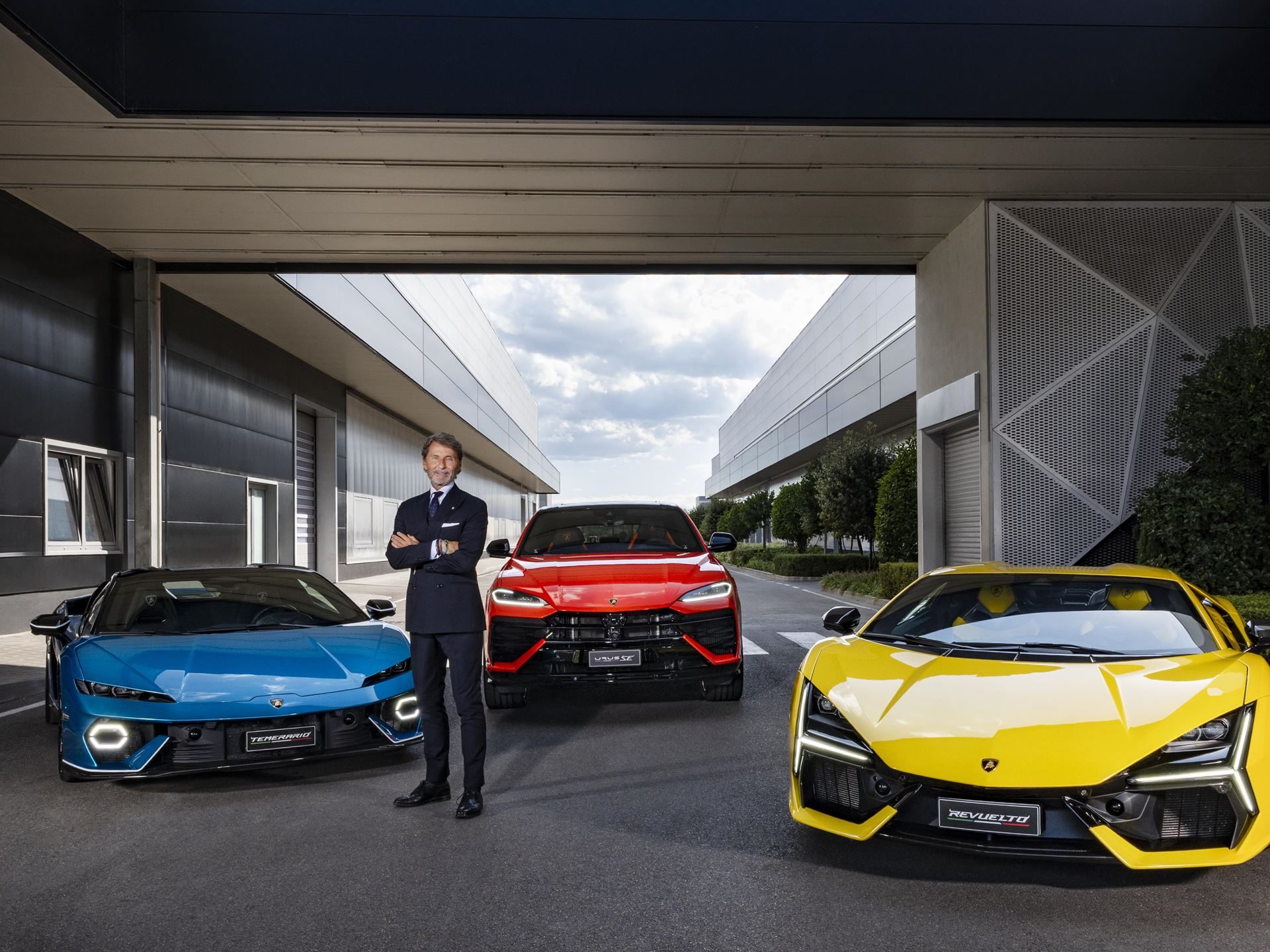 Lamborghini'S 24.6% Profit Margin Bankrolls The Temerario Era, Even As Tariffs And Currency Bite 7 Stephan winkelmann standing with arms crossed in front of the lamborghini hybrid lineup including temerario, urus, and revuelto