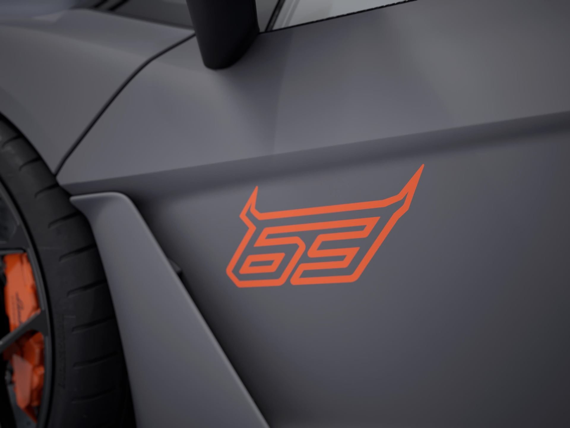Revuelto Na63: 63 Units, Two Countries, And Lamborghini'S Sharpest Play For North American Collectors 7 Close-up of the '63' logo in bright orange on the matte grey side panel of the revuelto na63 with orange brake caliper visible