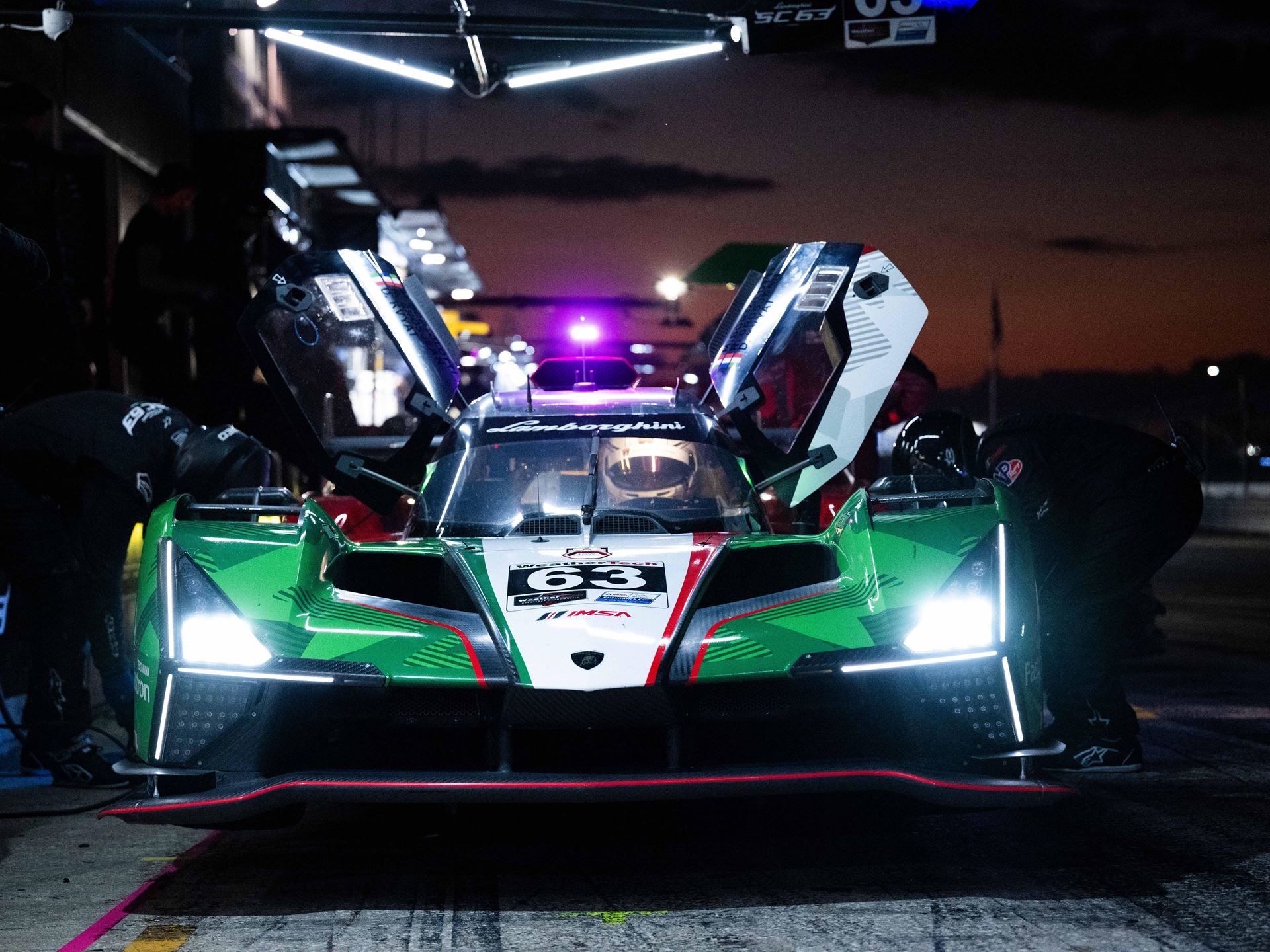 Kvyat Rejoins Grosjean And Mortara As The Lamborghini Sc63 Heads To Its Last Imsa Gtp Start 9 Lamborghini sc63 in the pit lane at dusk with doors open, pit crew attending to the car, and led headlights illuminated