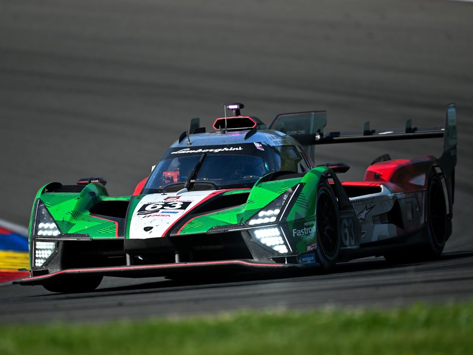 Lamborghini SC63 LMDh prototype in green, white, and red livery racing on track