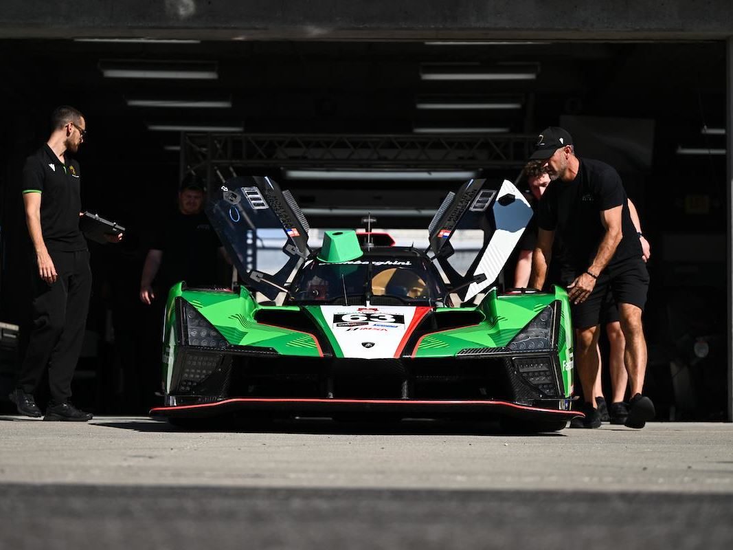 The Lamborghini Sc63'S 'Evo Joker' Suspension Finally Showed What This Car Can Do, Just As The Program Winds Down 13 Lamborghini sc63 with doors open being serviced by crew members in the pit garage, showing green, red, and white livery
