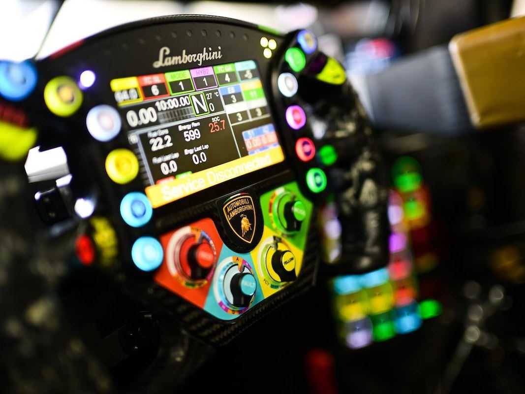 The Lamborghini Sc63'S 'Evo Joker' Suspension Finally Showed What This Car Can Do, Just As The Program Winds Down 9 Close-up of the illuminated steering wheel of the lamborghini sc63 showing buttons, dials, and digital display