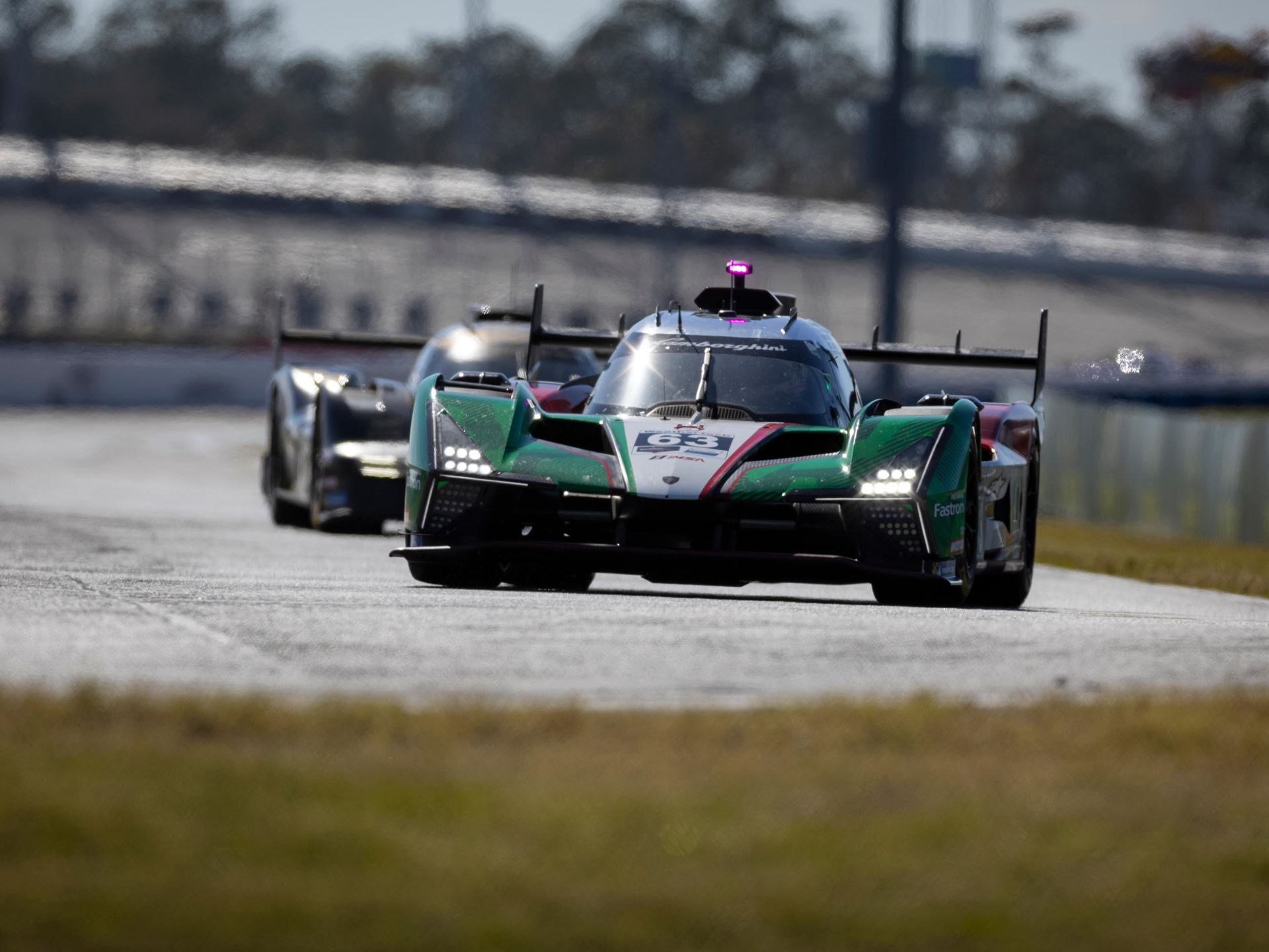 Lamborghini Sc63 Returns To Sebring Seeking Redemption After Daytona Retirement 3 The lamborghini sc63 leading another prototype on a sunny racetrack