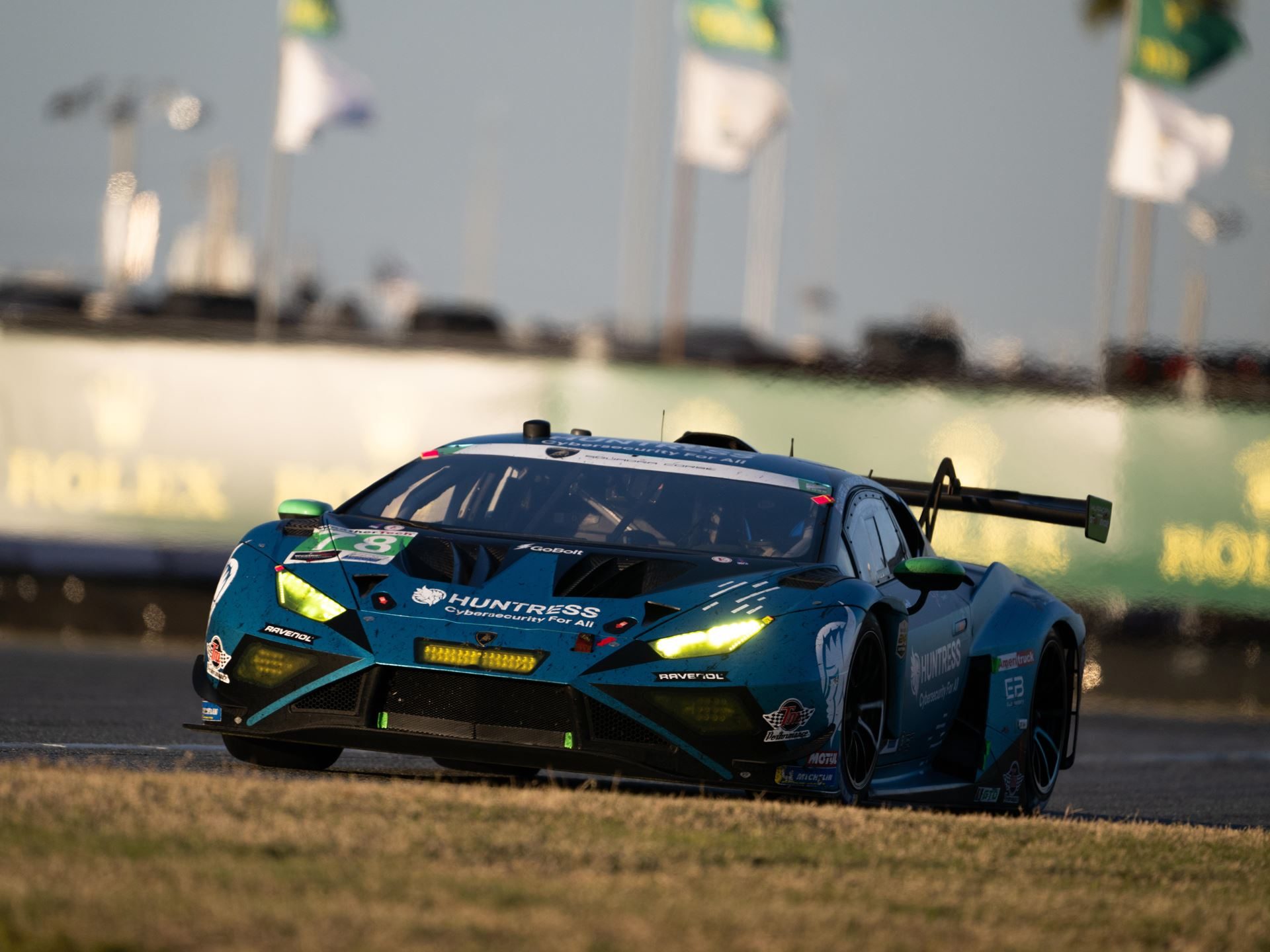 Lamborghini Sc63 Returns To Sebring Seeking Redemption After Daytona Retirement 5 A teal lamborghini huracán gt3 evo2 with bright yellow headlights racing on track