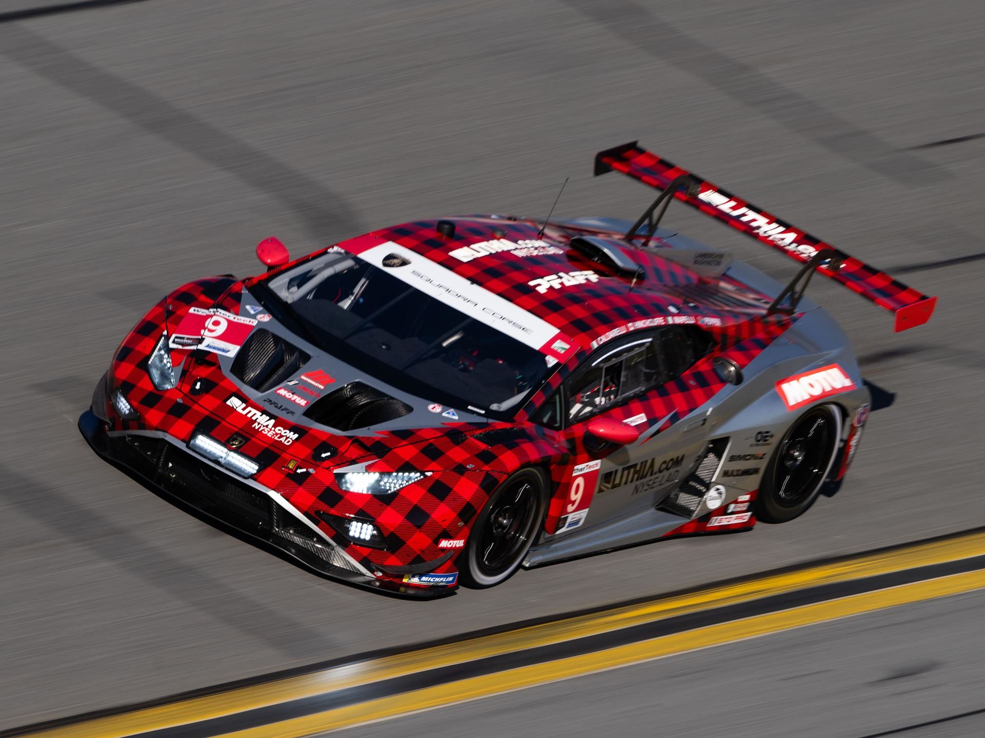 Lamborghini Sc63 Returns To Sebring Seeking Redemption After Daytona Retirement 9 A lamborghini huracán gt3 evo2 in red and black plaid livery cornering on track
