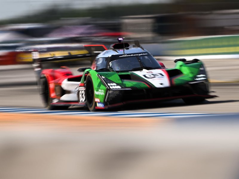 Lamborghini SC63 number 63 racing on track in green, white, and red livery