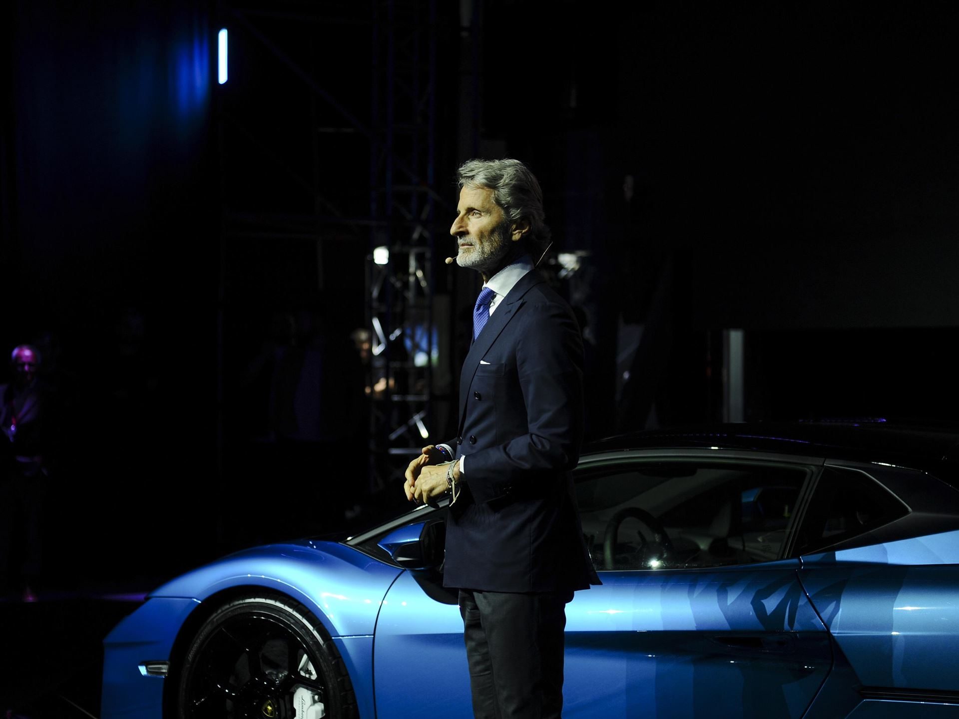 Lamborghini Opens Its First Official Showroom In Georgia, Premiering The Temerario In Tbilisi 5 Stephan winkelmann on stage beside a blue lamborghini at the tbilisi showroom launch event