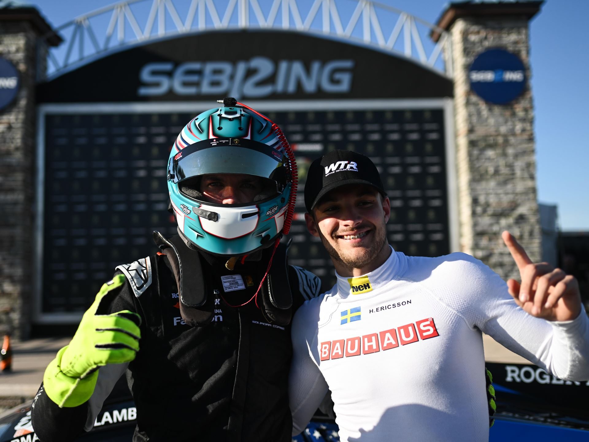 41 Huracáns Head To Laguna Seca As Wayne Taylor Racing Carries Five-Win Sebring Momentum 3 Two race car drivers smiling and posing in front of a sebring sign after a successful super trofeo weekend