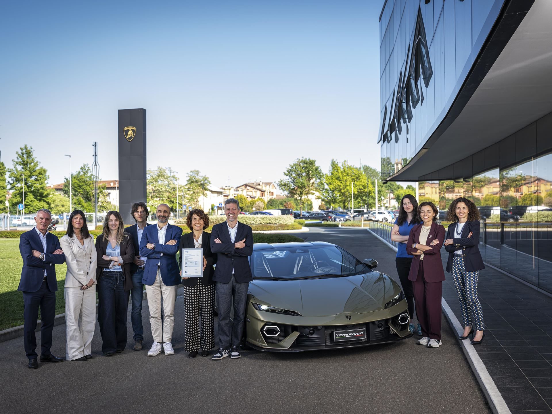 Lamborghini executives and staff posing at sant'agata bolognese headquarters during the dnv esg recognition ceremony