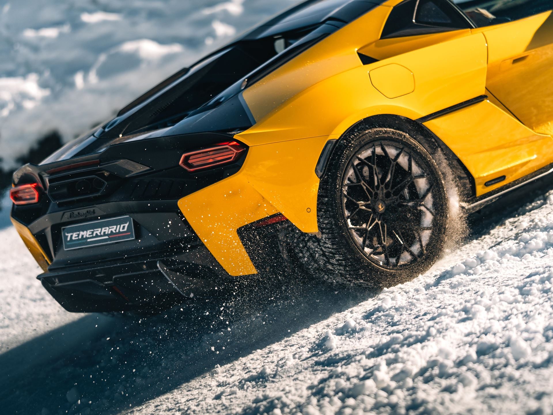 Lamborghini'S Temerario Drifts On Alpine Ice, Proving Its Hybrid System Works Where Grip Doesn'T 9 Yellow lamborghini temerario accelerating on snow, rear wheels kicking up powder