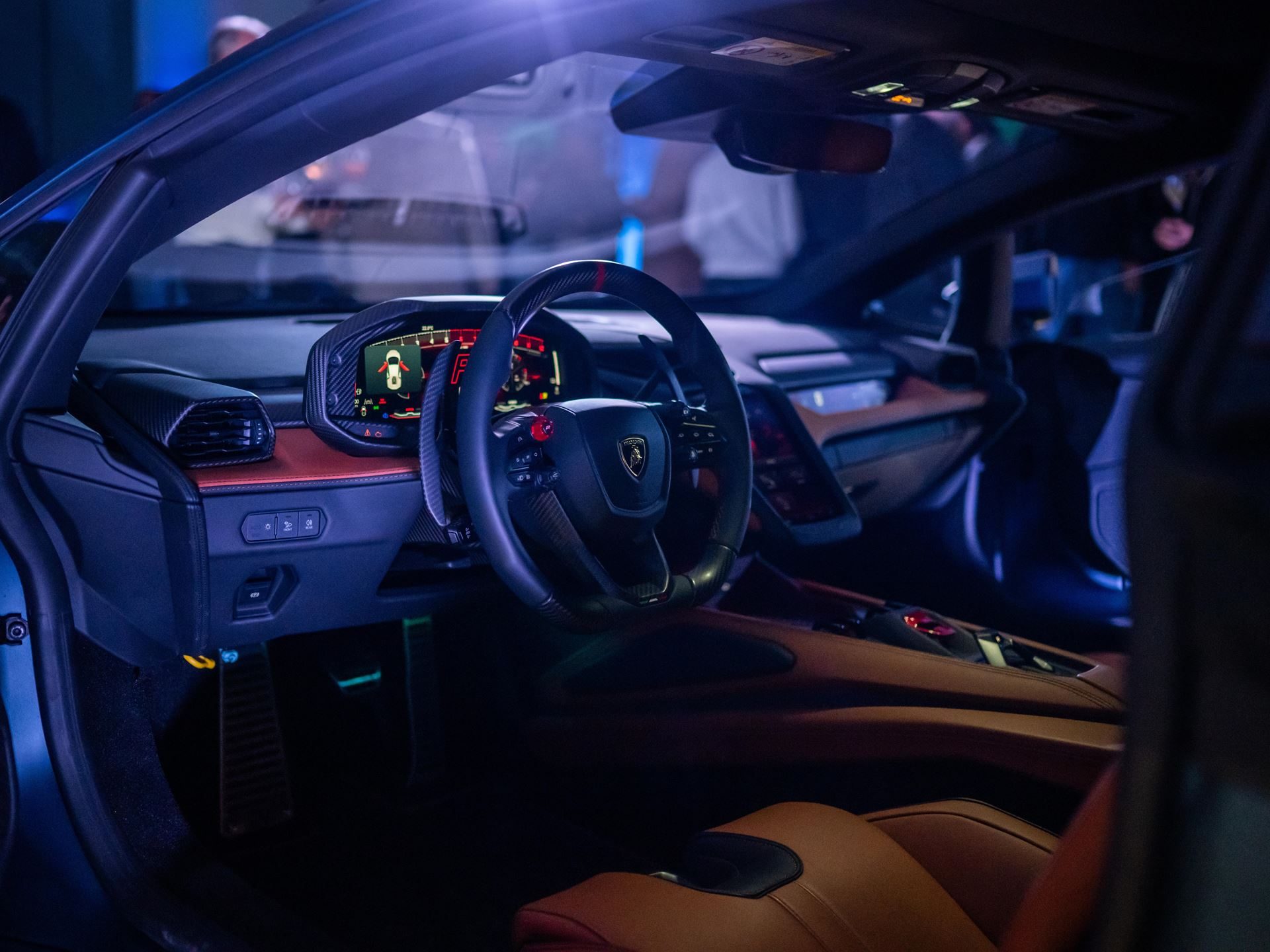 Lamborghini Temerario: A 10,000 Rpm V8 And Three Electric Motors Replace The Huracán 9 Lamborghini temerario interior showing flat-bottom steering wheel, digital instrument cluster, hexagonal air vents, and brown leather seats