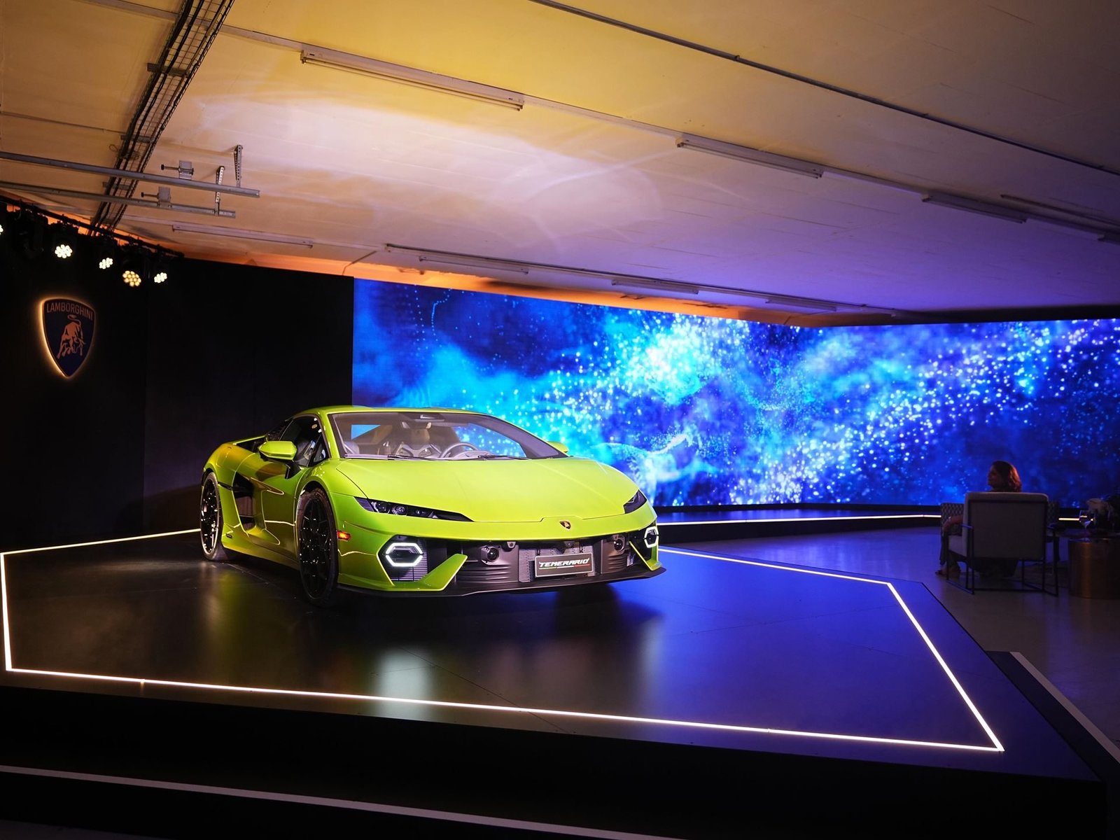 Bright lime green Lamborghini Temerario displayed on a lit stage at the Kyalami Grand Prix Circuit launch event in Johannesburg