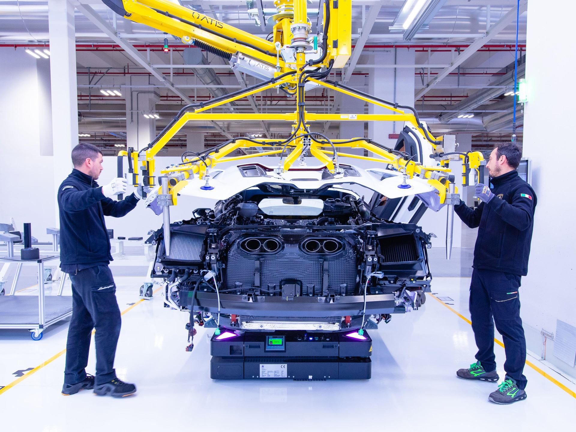 Lamborghini'S 12Th Consecutive Top Employer Award Reveals The Factory Floor Culture Behind Its Supercars 9 Two lamborghini technicians working on the rear section of a white urus on the assembly line with the engine bay exposed