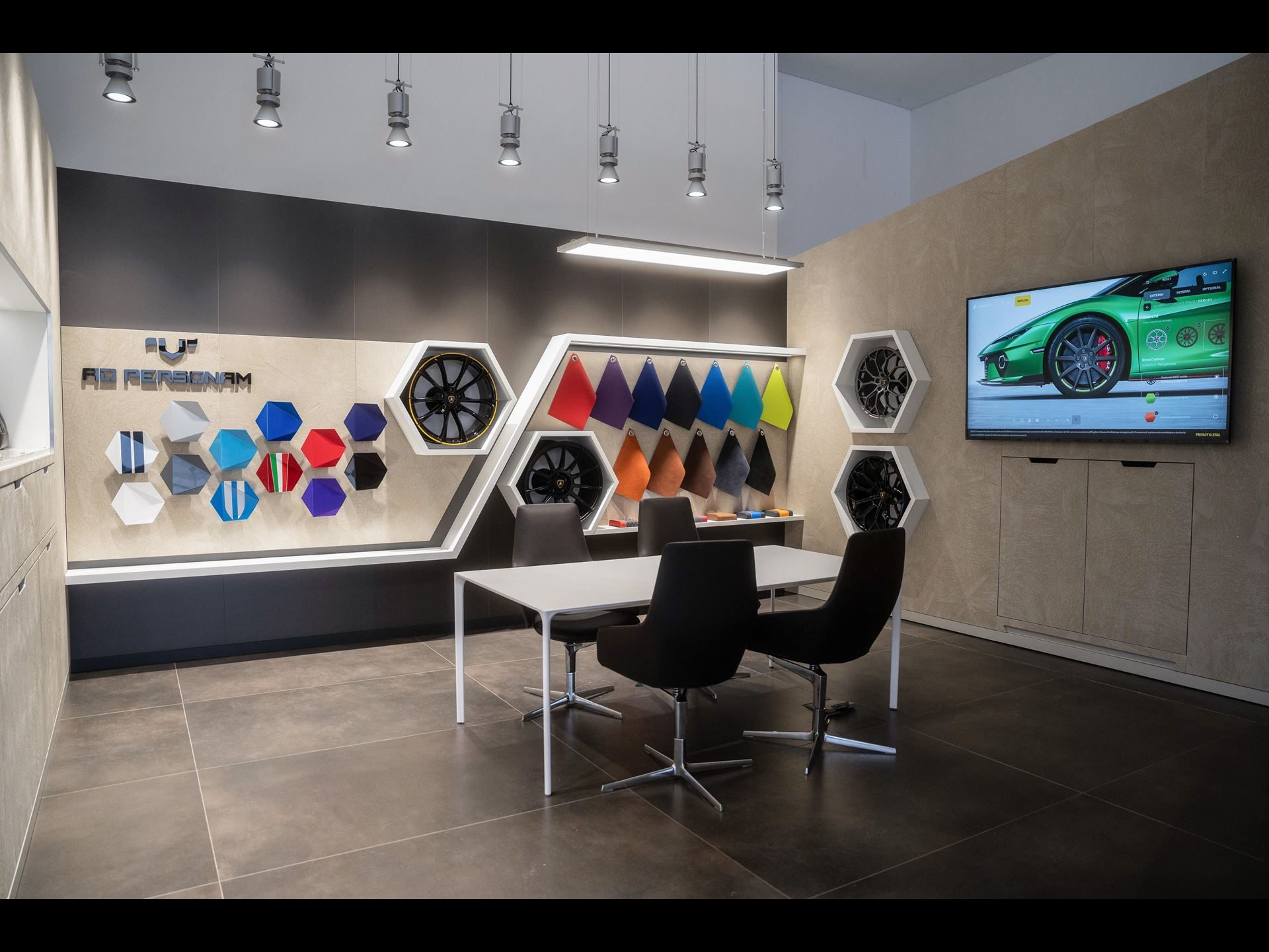 Lamborghini'S Seventh Italian Showroom Opens In Turin With 1,400 Square Meters And A 10,000-Rpm Centerpiece 5 Ad personam customization area in the lamborghini turin showroom with paint samples, wheel options, and a digital configurator screen