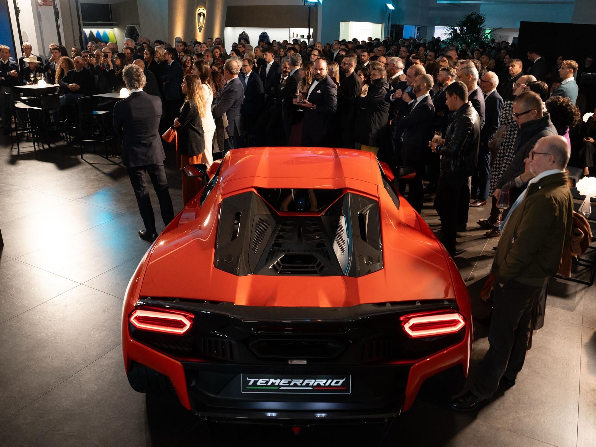 Lamborghini'S Seventh Italian Showroom Opens In Turin With 1,400 Square Meters And A 10,000-Rpm Centerpiece 11 Red lamborghini temerario on display at the turin showroom grand opening, surrounded by attendees