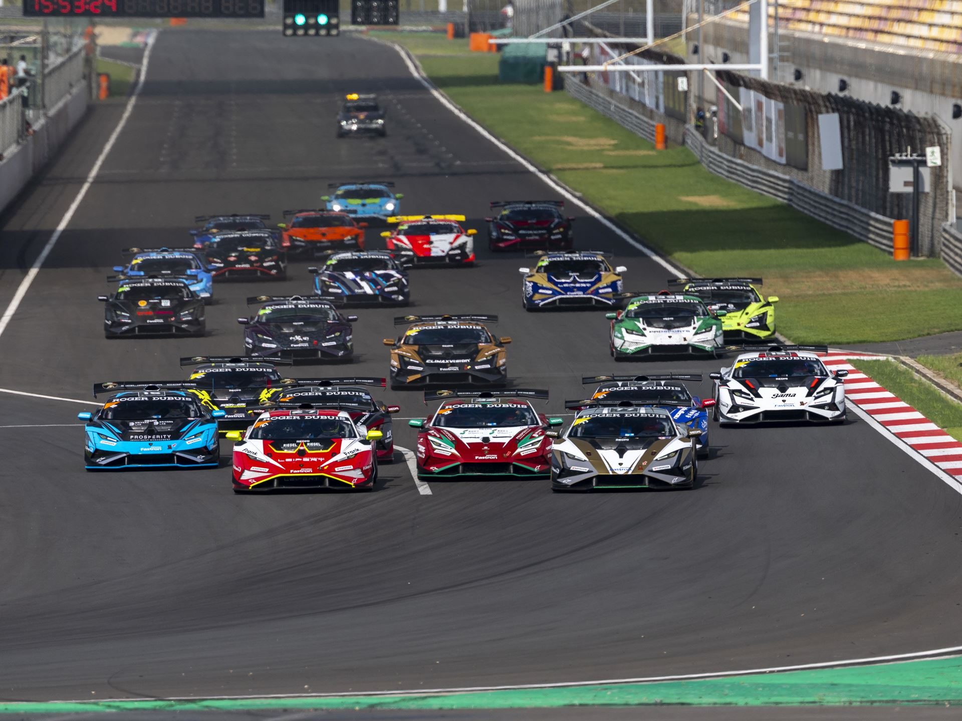 Eight Titles Still On The Line As 132 Drivers Converge On Misano For The 12Th Lamborghini World Finals 3 Wide shot of numerous lamborghini huracán super trofeo evo2 cars forming a large grid on a racetrack with diverse racing liveries