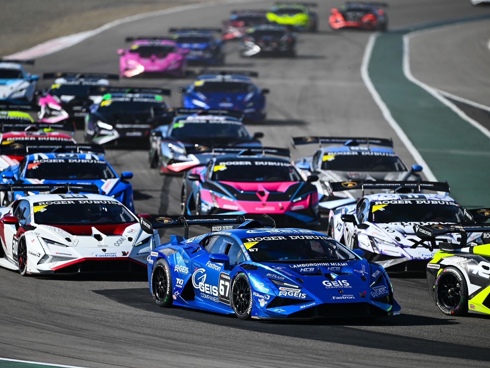 Eight Titles Still On The Line As 132 Drivers Converge On Misano For The 12Th Lamborghini World Finals 9 A blue lamborghini huracán super trofeo evo2 leads a group of race cars on a circuit