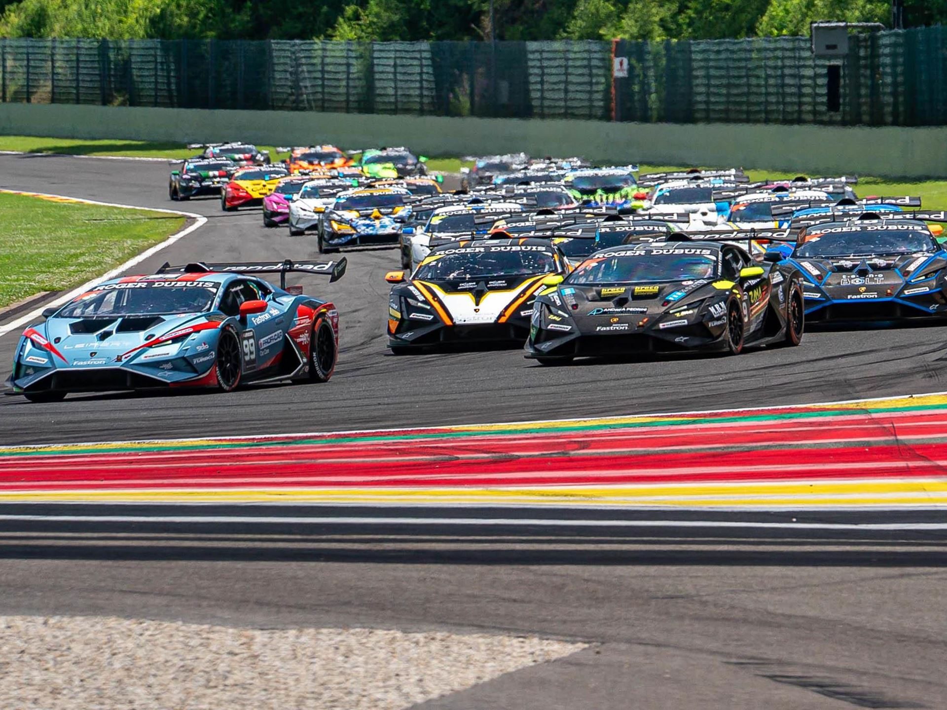 Eight Titles Still On The Line As 132 Drivers Converge On Misano For The 12Th Lamborghini World Finals 11 A large grid of lamborghini huracán super trofeo evo2 cars on a racetrack with a light blue car in the foreground