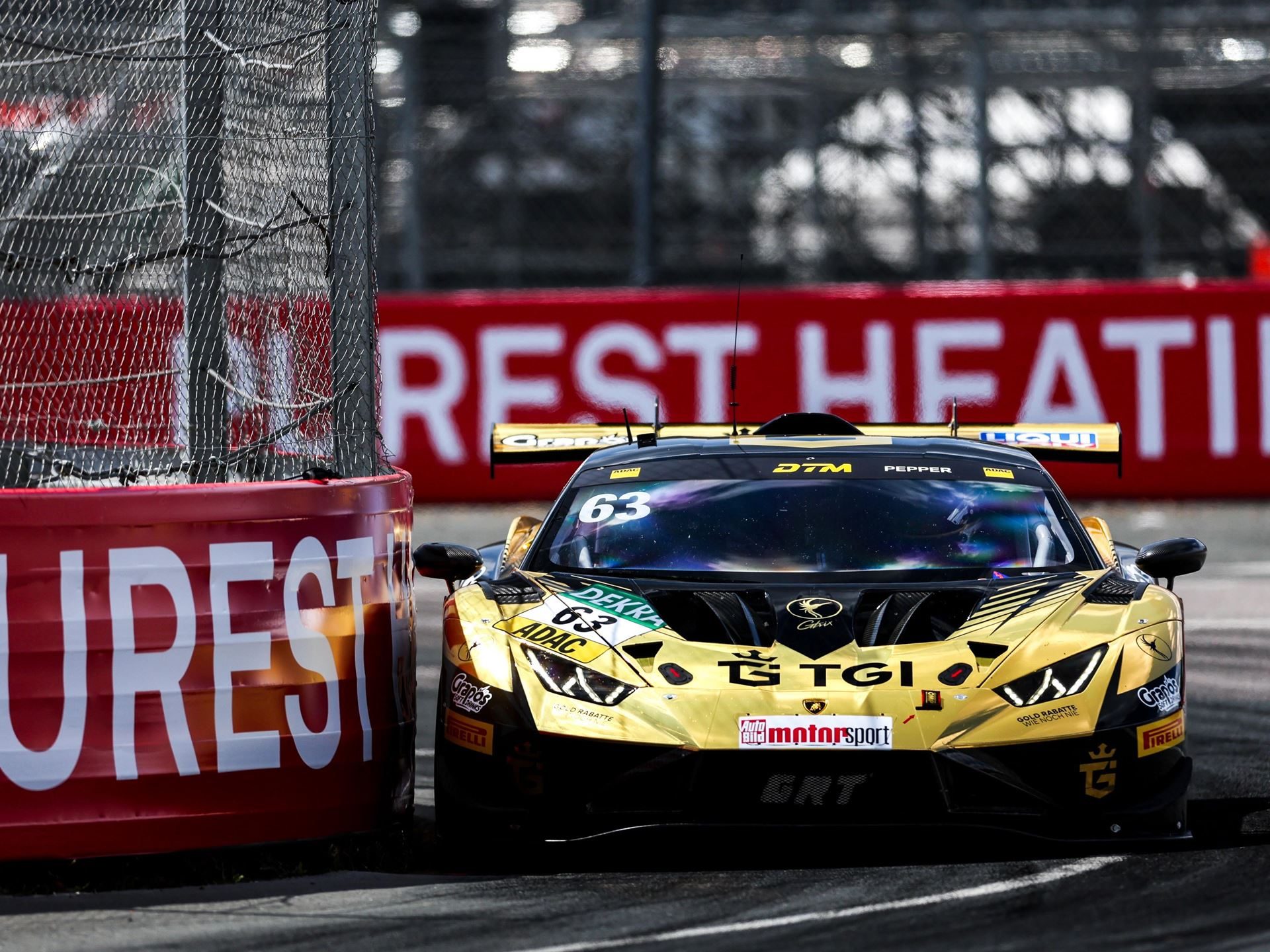 Jordan Pepper'S Norisring Pole-To-Flag Win Puts Lamborghini Back In The Dtm Title Fight 3 The gold and black lamborghini huracán gt3 evo2 navigating a tight corner at the norisring with red barriers visible