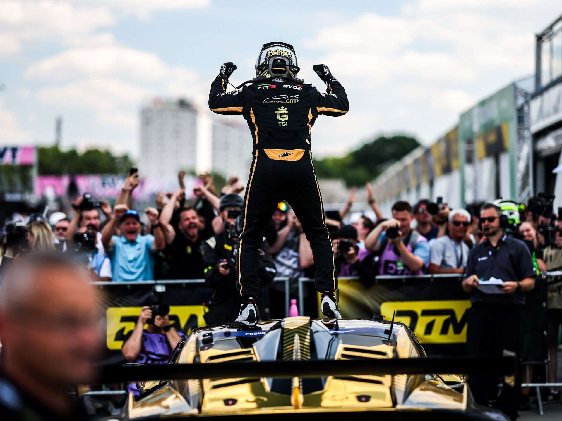 Jordan Pepper'S Norisring Pole-To-Flag Win Puts Lamborghini Back In The Dtm Title Fight 9 Jordan pepper standing triumphantly on top of the gold and black lamborghini huracán gt3 evo2, fists raised to a cheering crowd