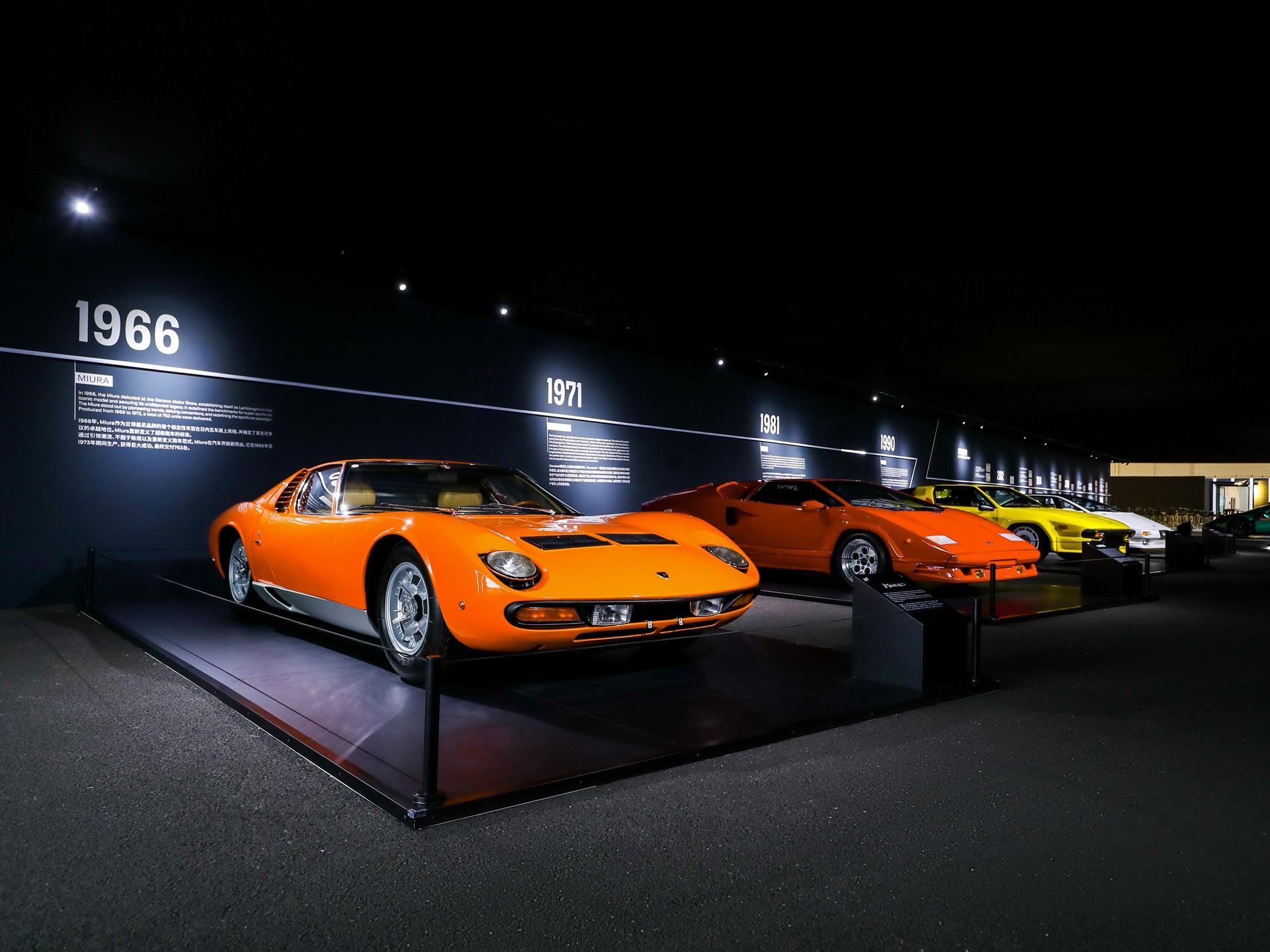 Heritage display of lamborghini supercars including miura, countach, diablo, and murciélago arranged chronologically in exhibition hall