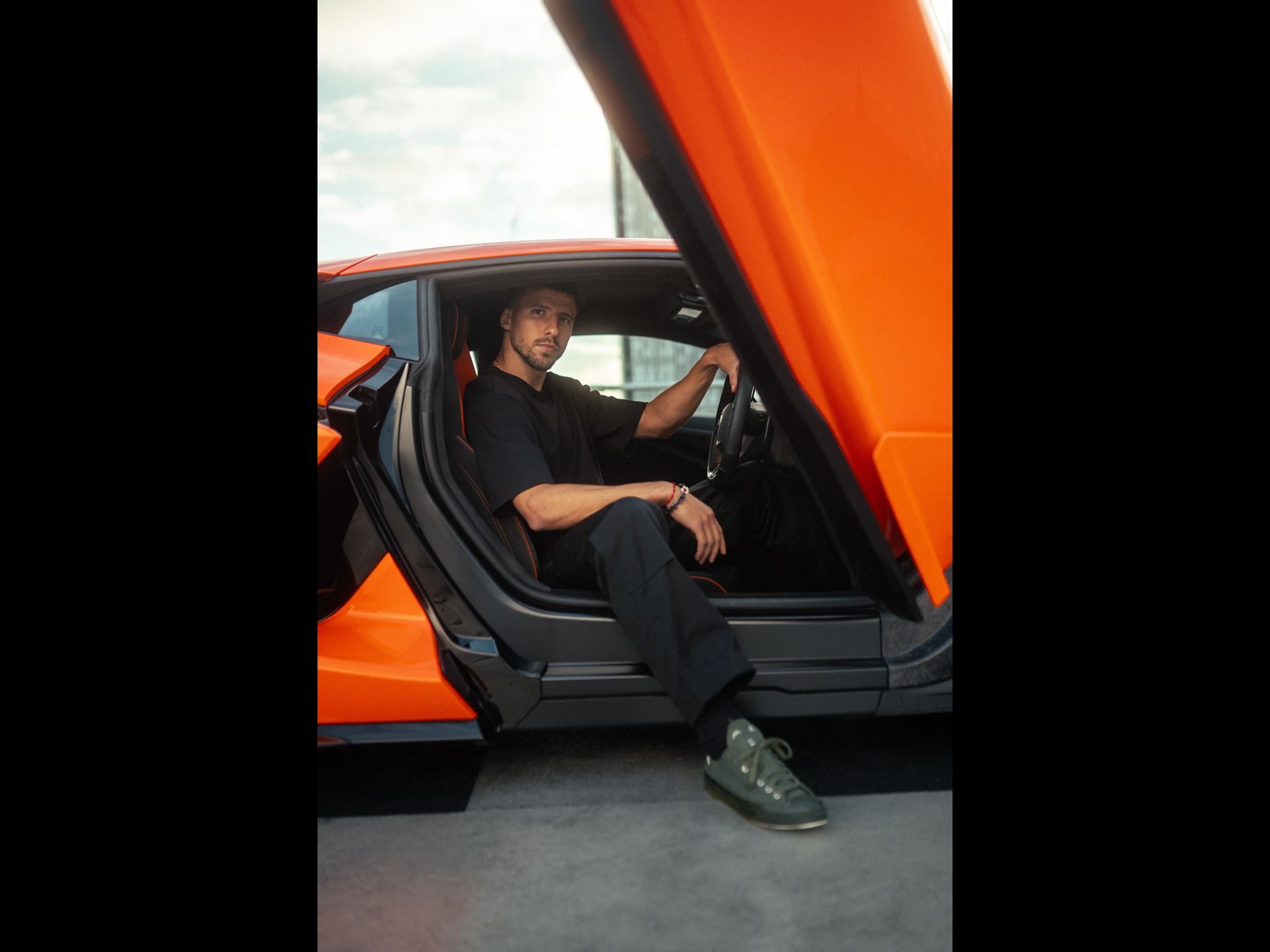 Lamborghini Taps Manchester City'S Rúben Dias To Front Its 1,001-Hp Flagship 5 Rúben dias seated inside the orange lamborghini revuelto with its scissor door open