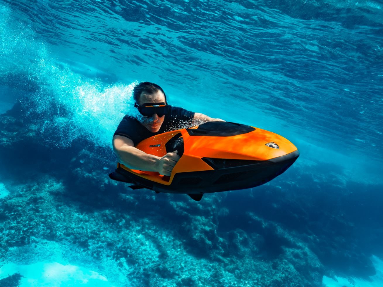 Cayago'S Most Powerful Seascooter Wears Lamborghini Colors And A Familiar Start Button 9 Rider piloting an orange lamborghini-branded seabob underwater with coral visible below