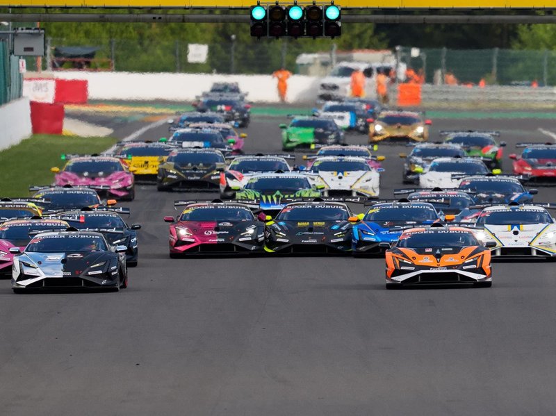 Multiple Lamborghini Huracán Super Trofeo EVO2 race cars lined up on the starting grid under green lights