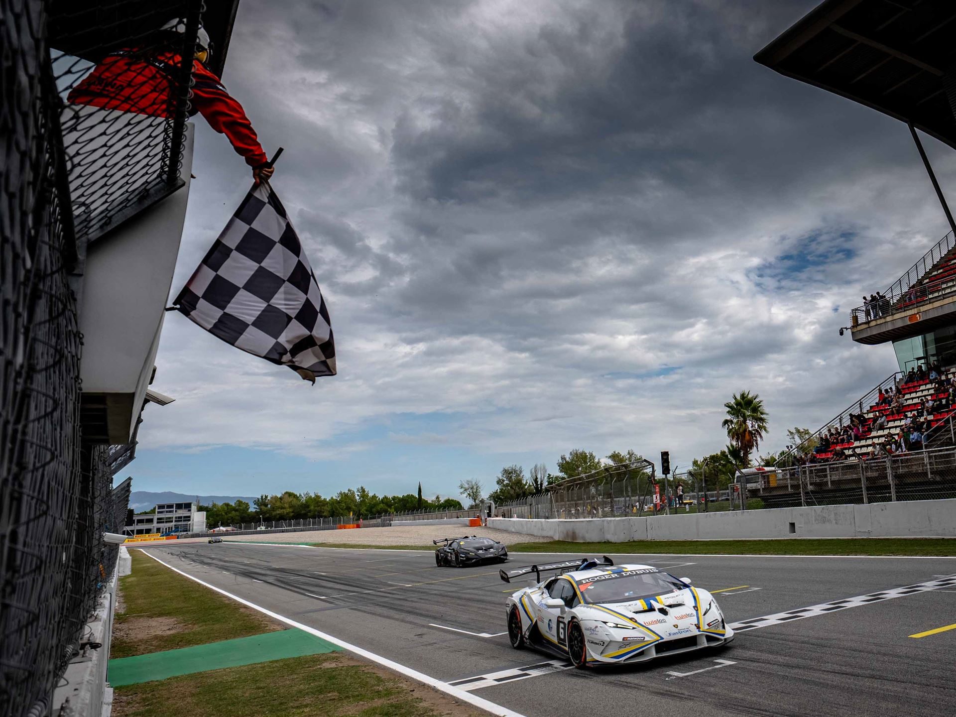 Cmr'S Dimitrov And Guerin Lock Up Super Trofeo Europe Pro-Am Title With A Round To Spare 5 A white lamborghini huracán super trofeo evo2 crosses the finish line under a checkered flag at barcelona