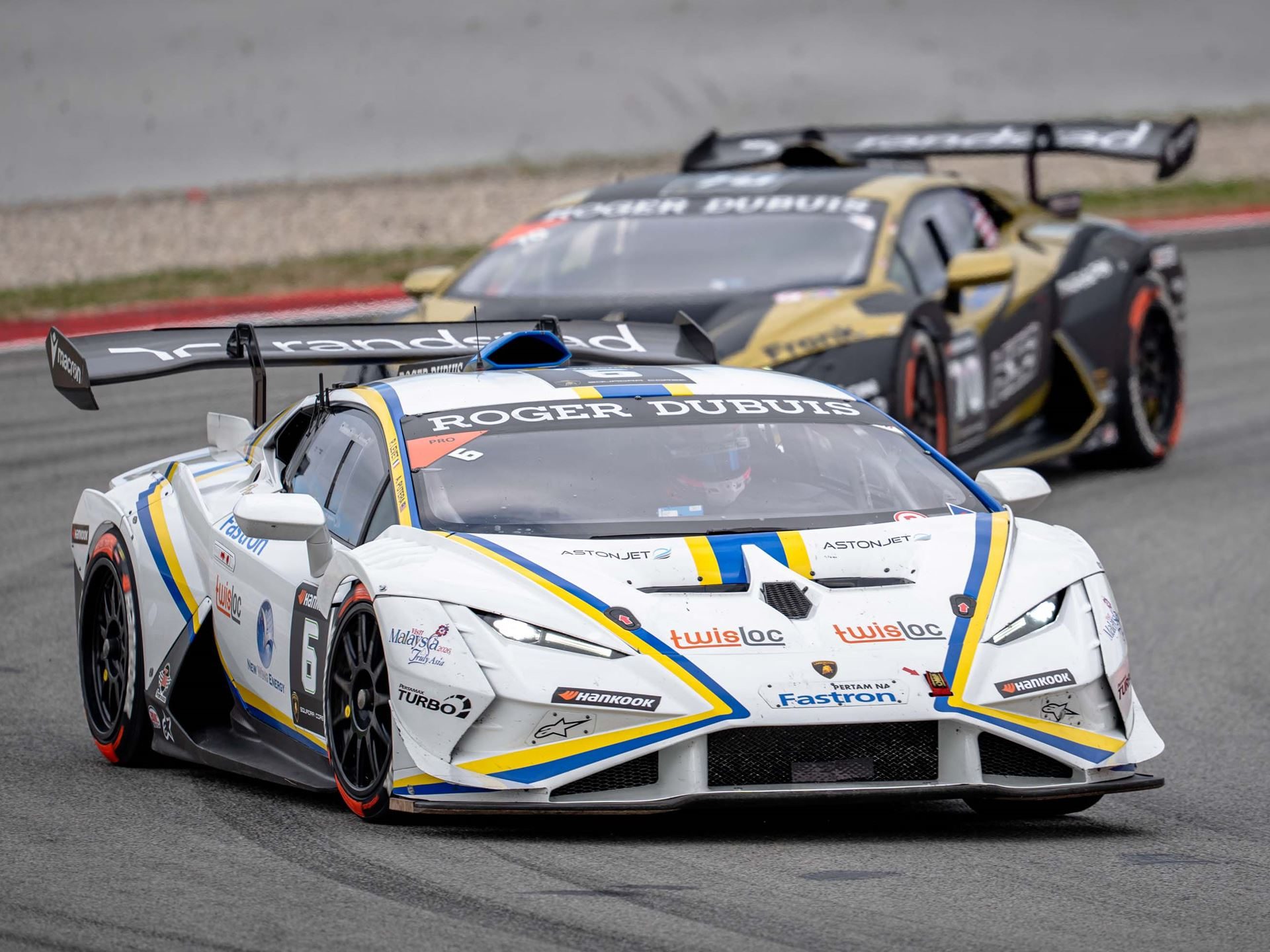 Cmr'S Dimitrov And Guerin Lock Up Super Trofeo Europe Pro-Am Title With A Round To Spare 9 A white lamborghini huracán super trofeo evo2 with blue and yellow accents leads another car on track