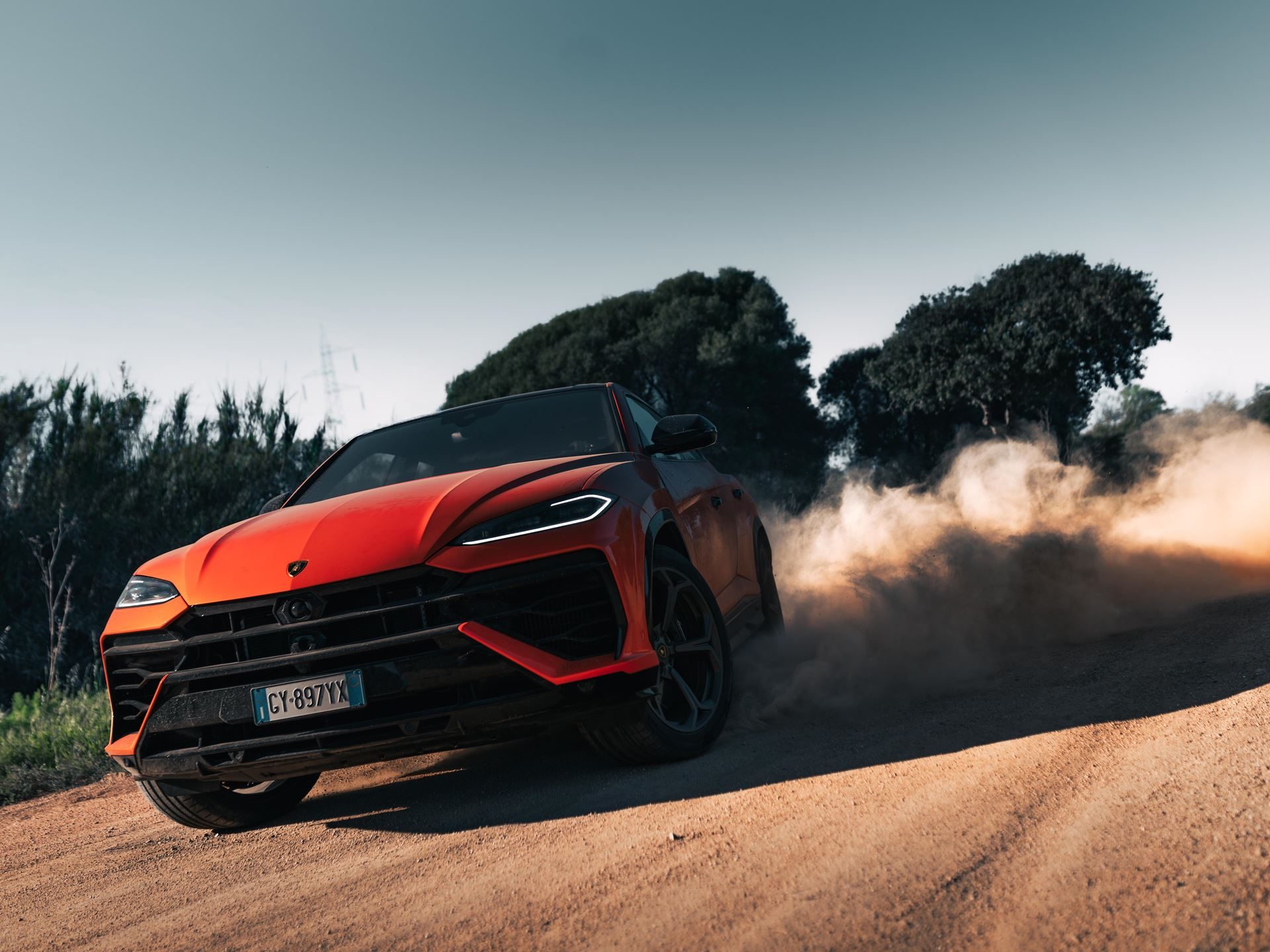 The Urus Se Staked Lamborghini'S Hybrid Credibility On Sardinian Dirt 3 Orange lamborghini urus kicking up dust on a sardinian dirt road