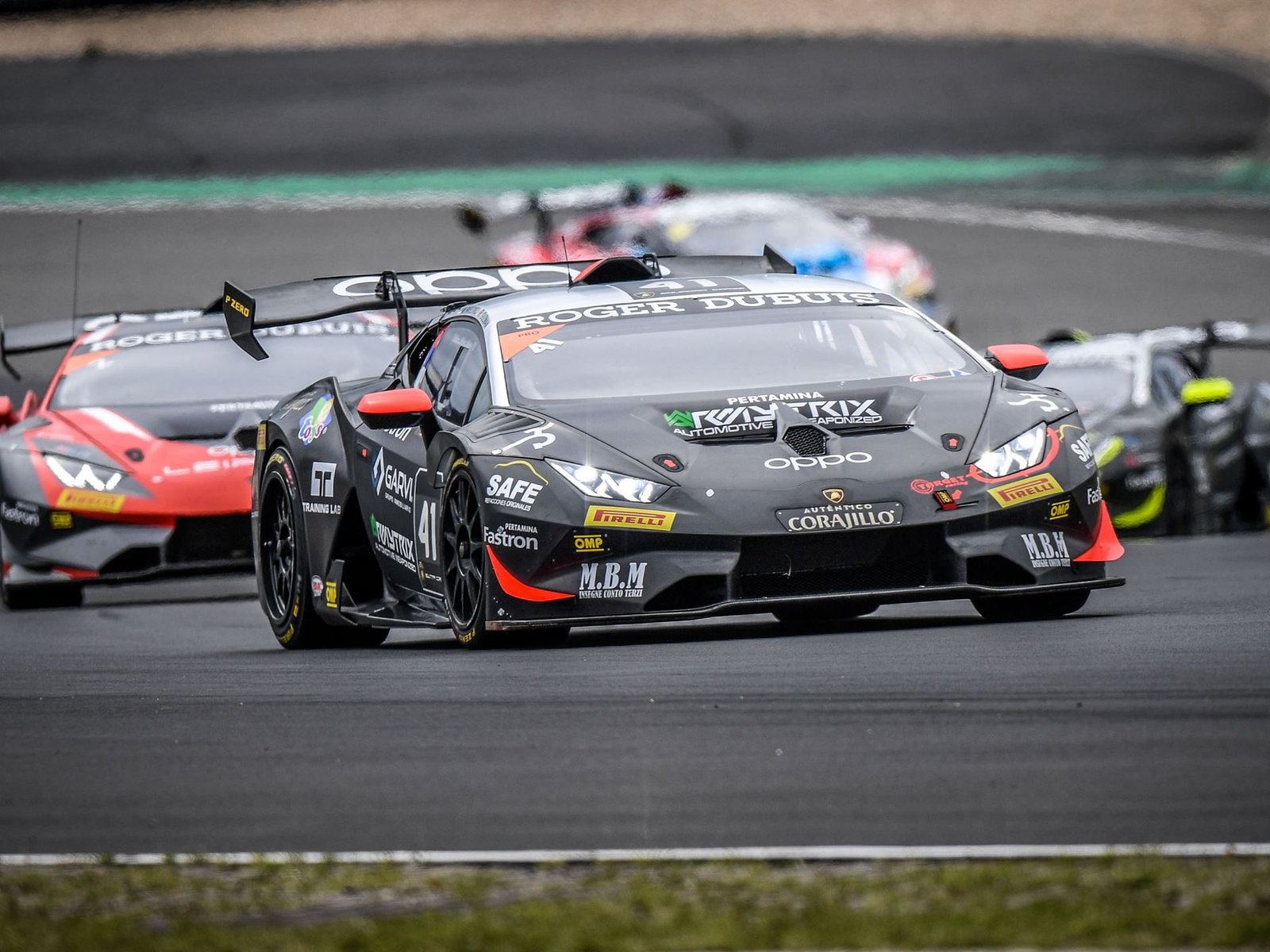 Black Lamborghini Huracán Super Trofeo EVO number 41 leading a pack of race cars on track