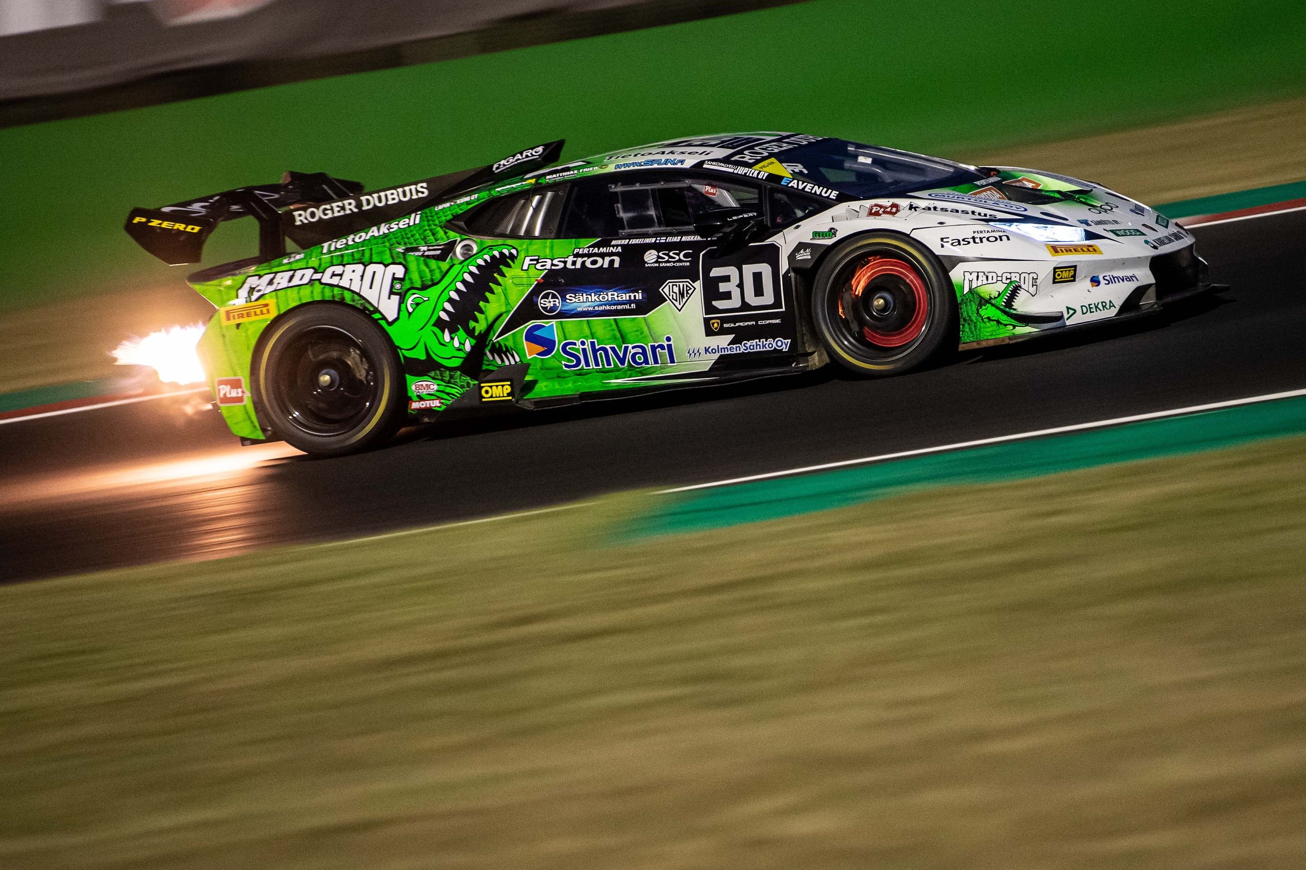 The Huracán Super Trofeo Evo2 Gets Its First Full Season: Six Rounds, Five Countries, And A Preview Of Lamborghini'S Design Future 3 A green and white lamborghini huracán super trofeo evo2 racing at night with exhaust flames visible