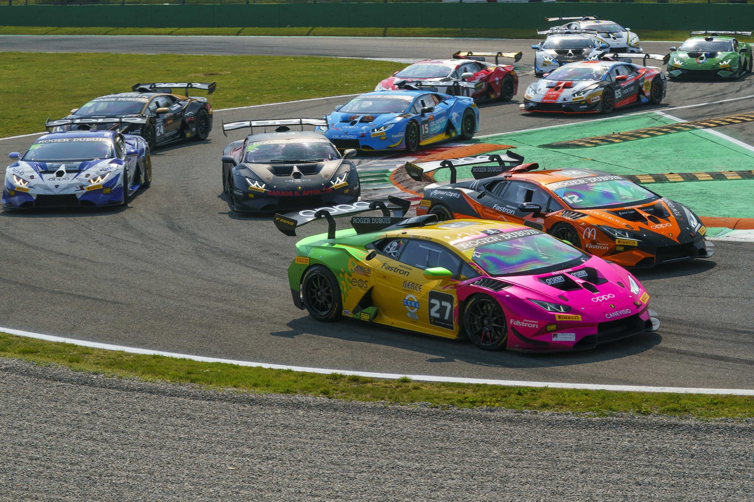 The Huracán Super Trofeo Evo2 Gets Its First Full Season: Six Rounds, Five Countries, And A Preview Of Lamborghini'S Design Future 7 Multiple lamborghini huracán super trofeo evo2 race cars navigating a corner in close formation on a sunny day