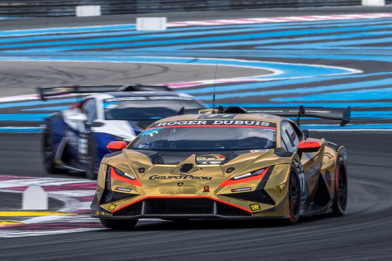 A gold Lamborghini Huracán Super Trofeo EVO2 race car leads another car on track during the 2023 Super Trofeo Europe season