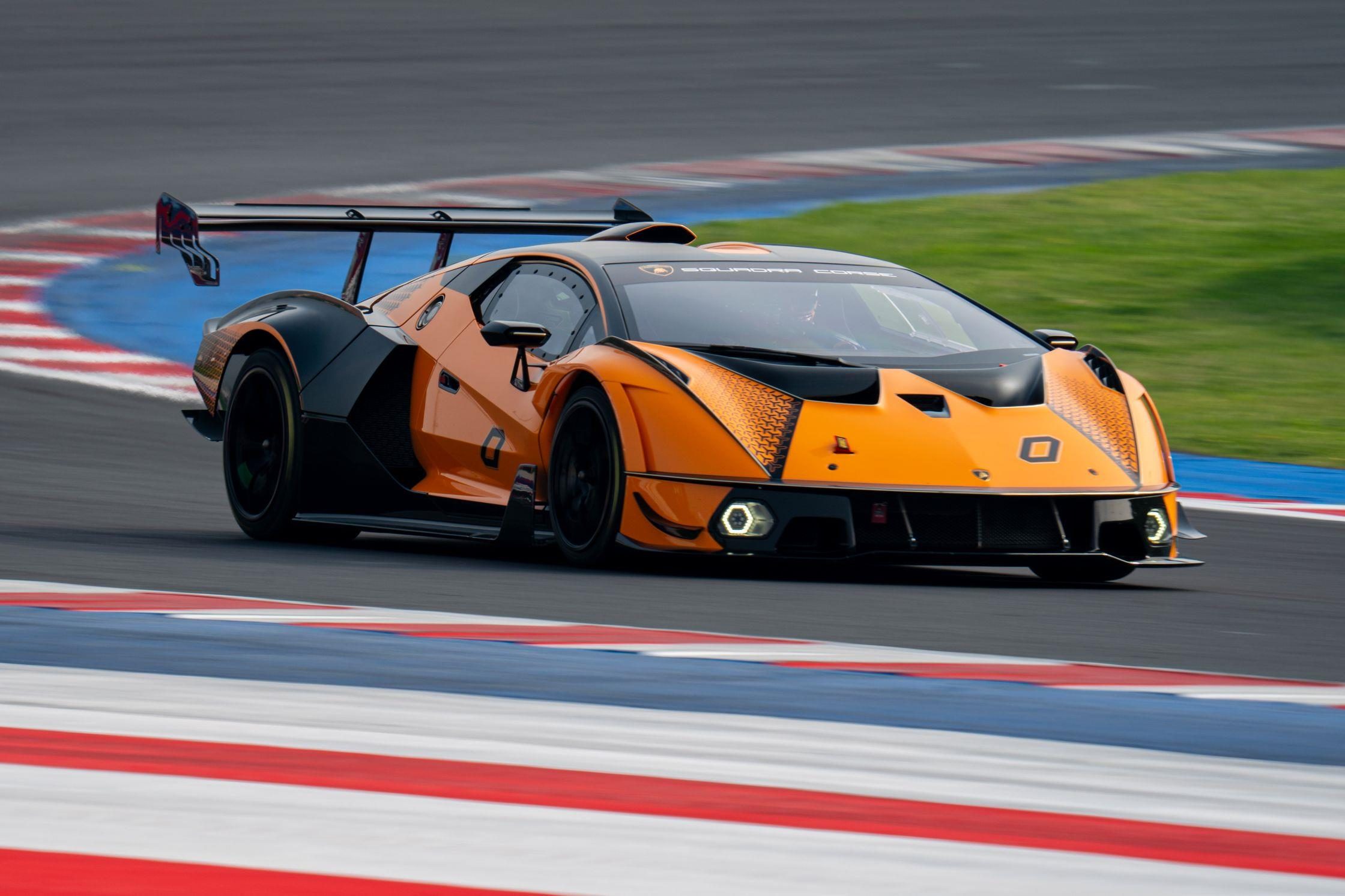 Four Weekends, 40 Cars, Factory Drivers: Inside Lamborghini'S 2026 Essenza Scv12 Program 3 Orange and black lamborghini essenza scv12 at speed on track showing aggressive aerodynamic design with large rear wing and front splitter