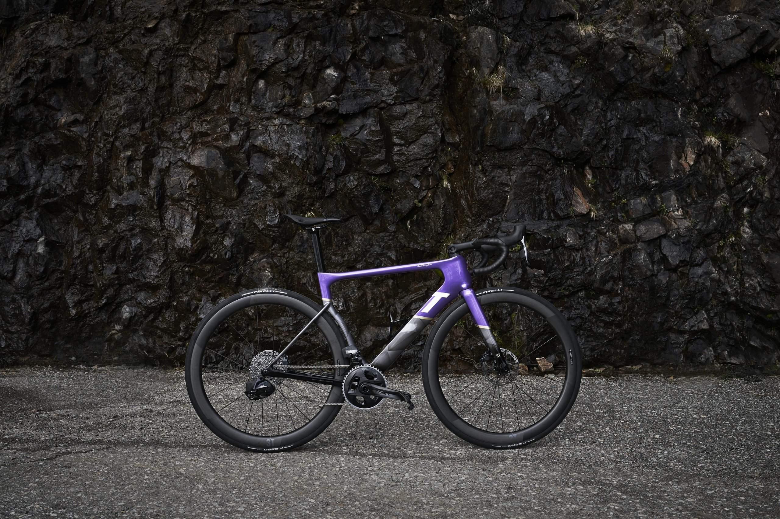 Lamborghini'S Centro Stile Designed Two New 3T Bicycles, And They Cost Less Than A Set Of Revuelto Brake Pads 7 Full side view of the purple viola pasifae 3t strada x automobili lamborghini road bicycle against a dark rocky cliff face