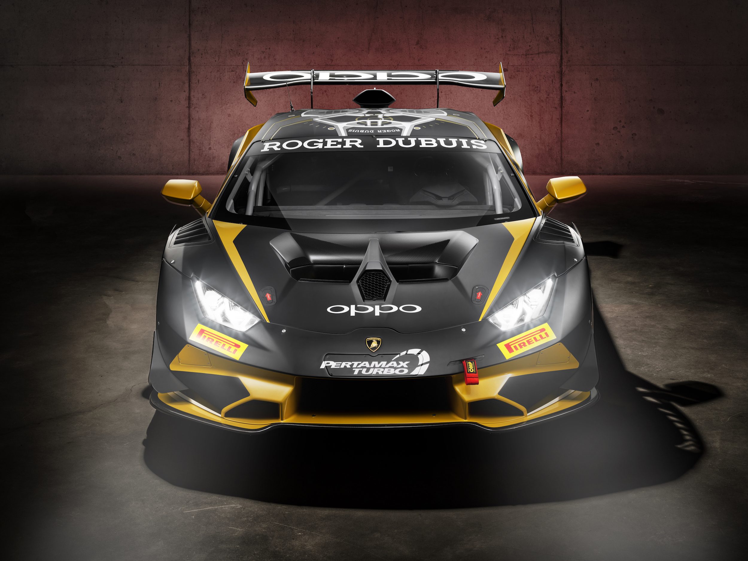 400 Huracán Race Cars, One Factory Floor: How Lamborghini'S Shared Production Line Built A Gt Dynasty 5 Front view of a lamborghini huracán gt3 evo in black and yellow racing livery under dramatic red studio lighting