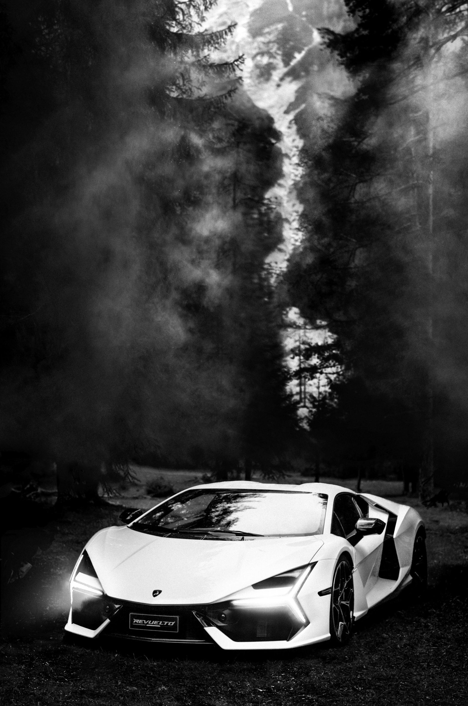 Black and white photograph of a white Lamborghini Revuelto on a forest floor with mist rising around it, captured by Anton Corbijn