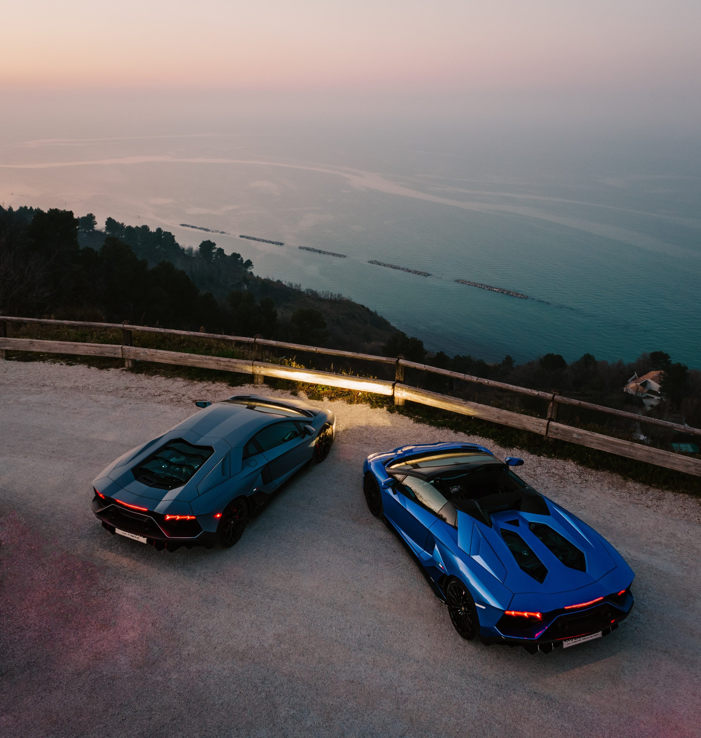 Aventador Ultimae'S Italian Farewell Drive Stages The End Of Lamborghini'S Pure V12 Era 3 Blue aventador ultimae roadster and grey ultimae coupé parked at a coastal overlook during twilight