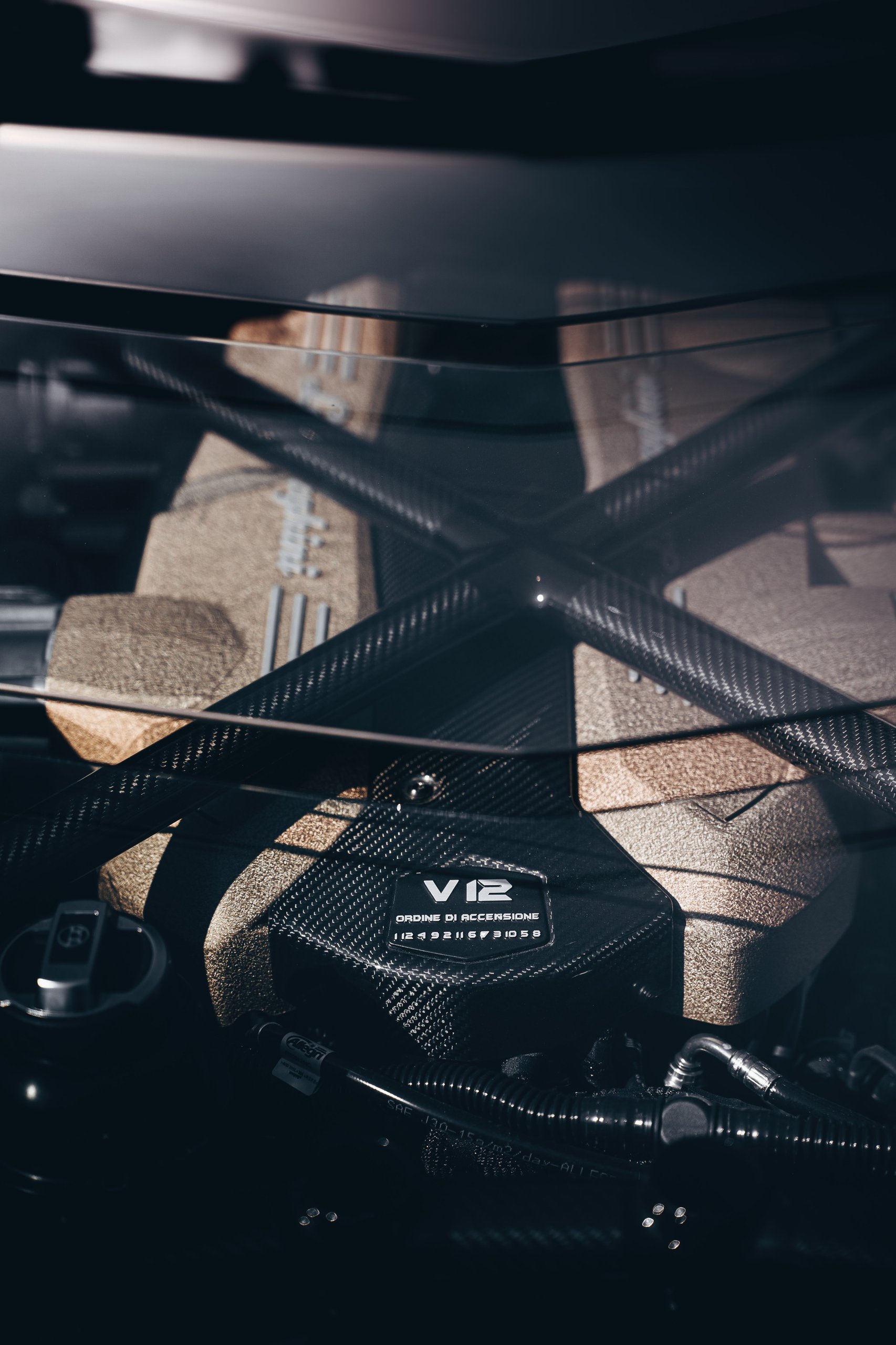 Aventador Ultimae'S Italian Farewell Drive Stages The End Of Lamborghini'S Pure V12 Era 7 Close-up of the aventador ultimae v12 engine showing gold-finished block and carbon fiber accents with ordine di accensione inscription