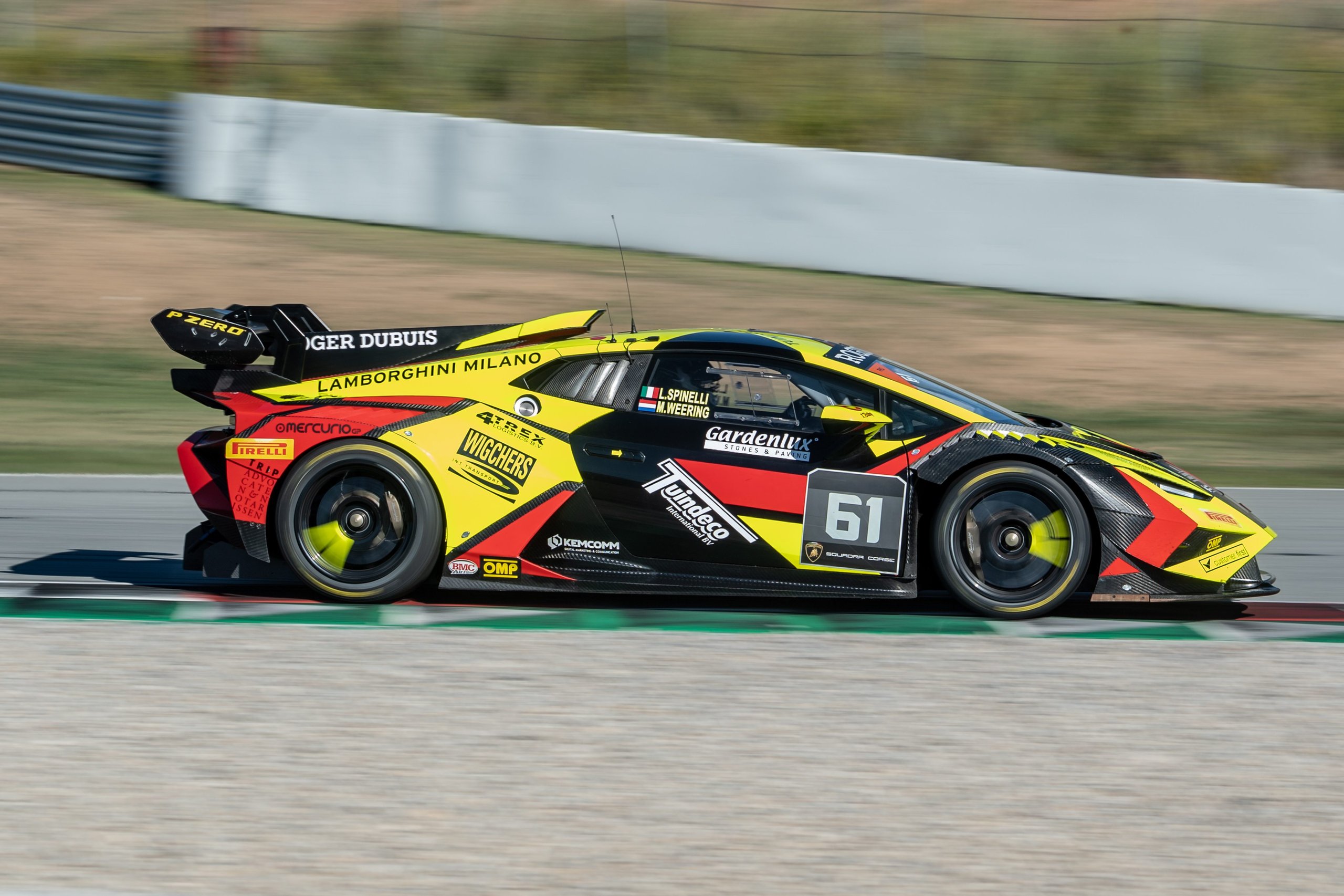 How Bonaldi Motorsport Turned A Botched Rival Pit Stop Into A Barcelona Title Sweep 3 The #61 bonaldi motorsport lamborghini huracán super trofeo evo2 in yellow, black, and red livery at speed on the barcelona circuit