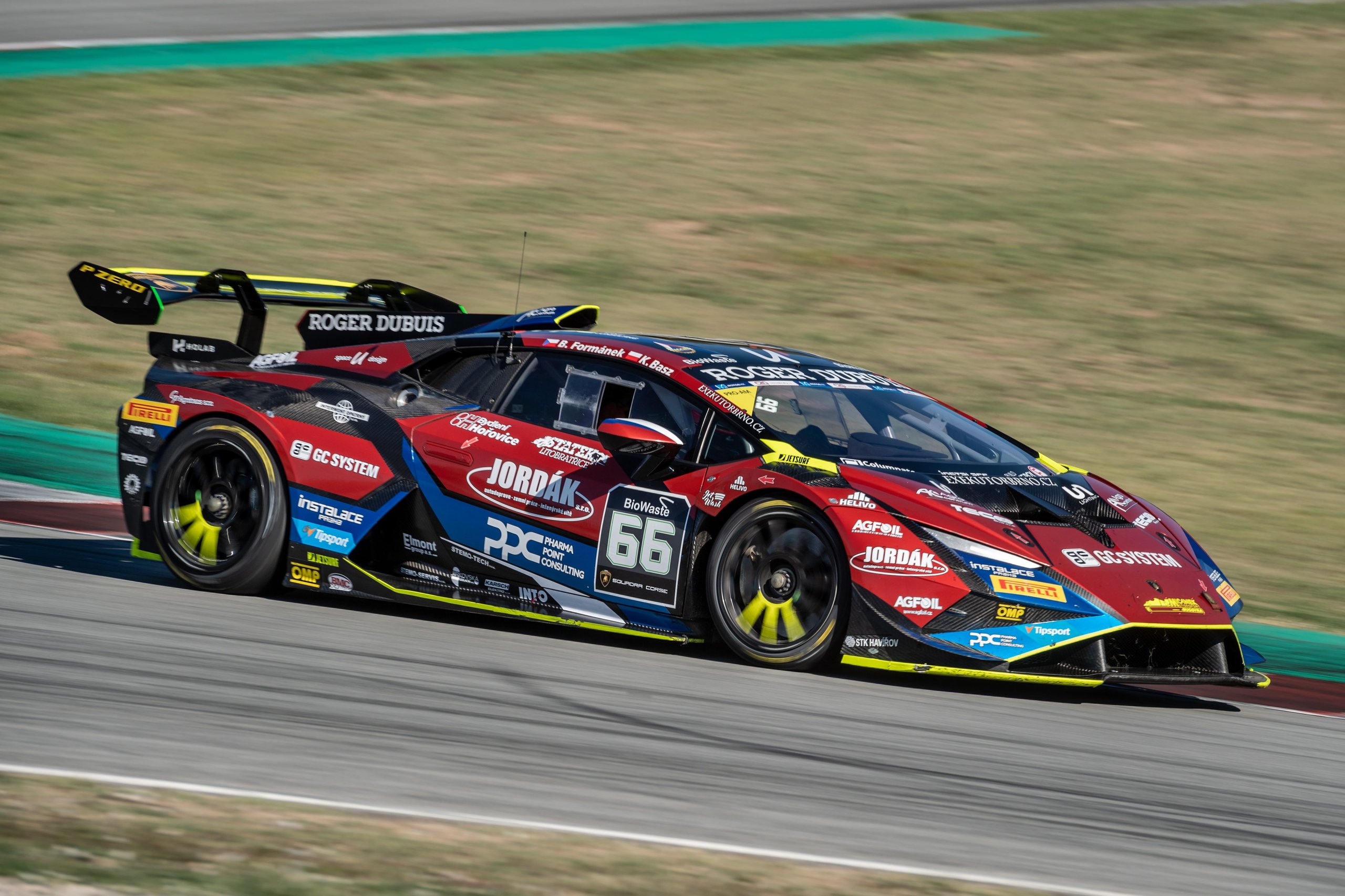 How Bonaldi Motorsport Turned A Botched Rival Pit Stop Into A Barcelona Title Sweep 7 A red, black, and yellow lamborghini huracán super trofeo evo2 number 66 at speed on the barcelona circuit with motion blur in the background