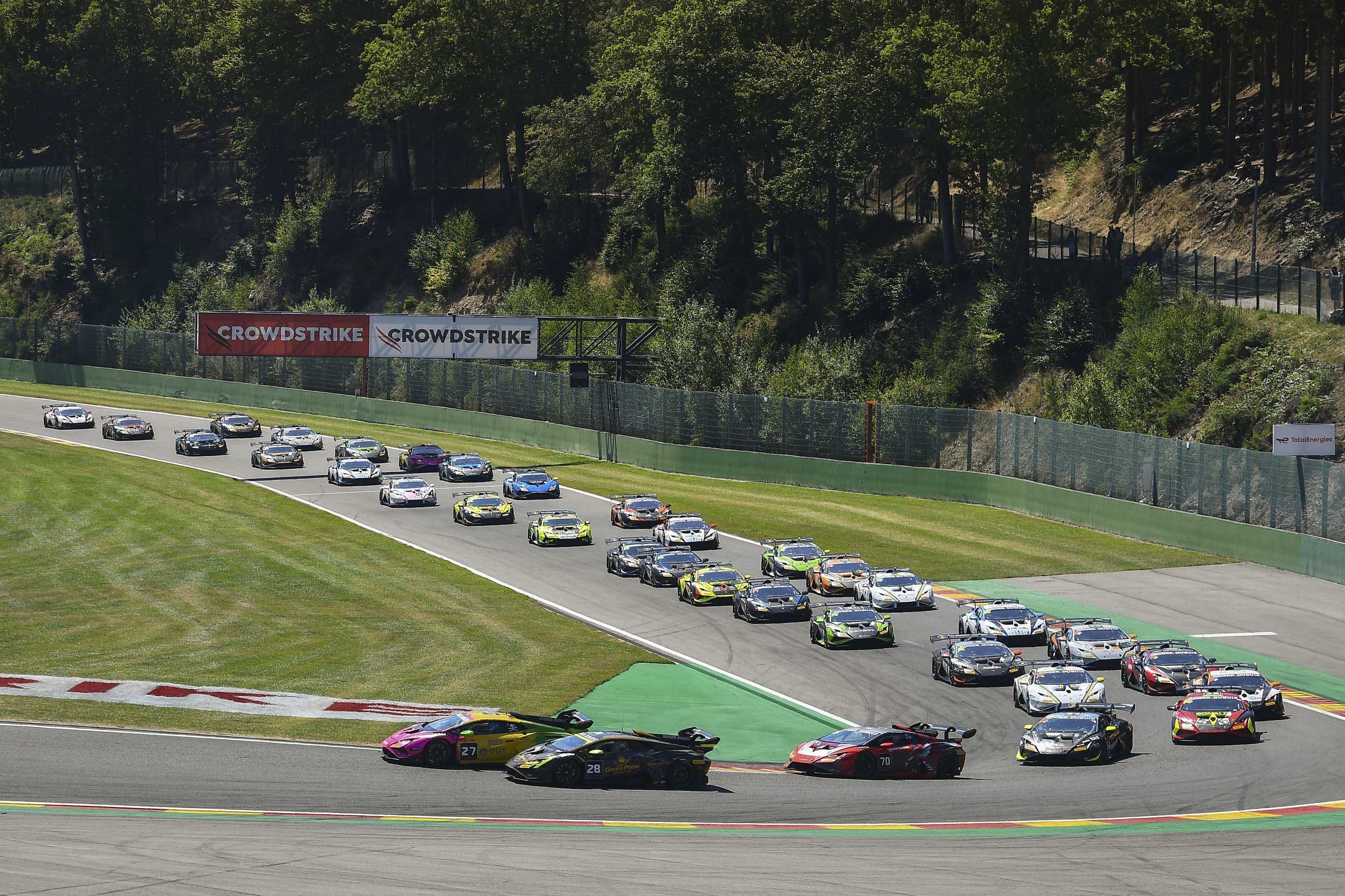 Bonduel'S Breakthrough At Spa: How Penalties And Chaos Handed A Local Hero His First Super Trofeo Europe Win 3 Pack of lamborghini huracán super trofeo evo2 race cars navigating a turn at spa-francorchamps with forest backdrop