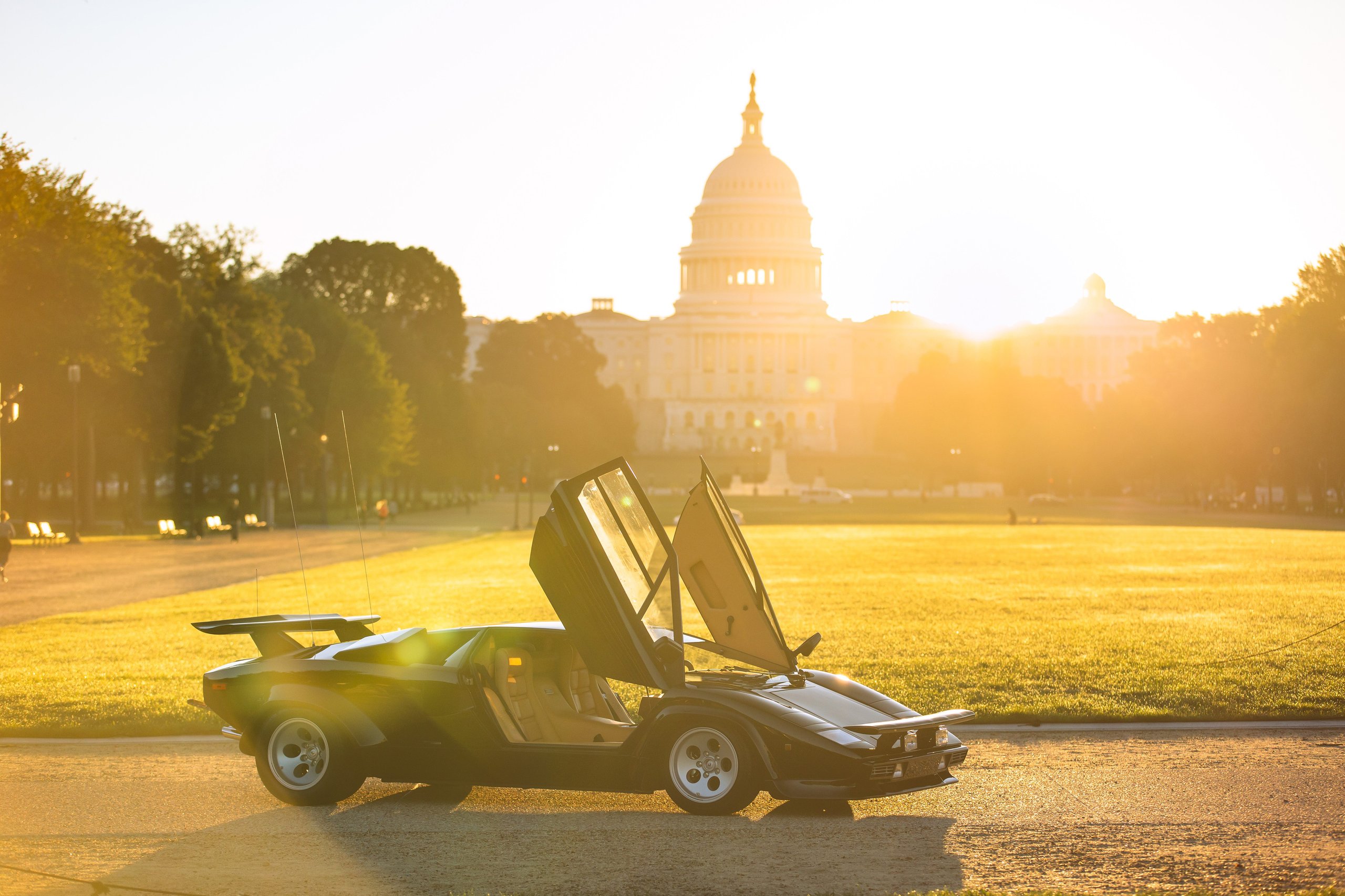 The 'Cannonball Run' Countach Now Sits On The National Mall, Officially One Of America'S Most Important Cars 9 The black cannonball run lamborghini countach lp 400 s with scissor doors open on a grassy area with the us capitol building in the background at golden hour