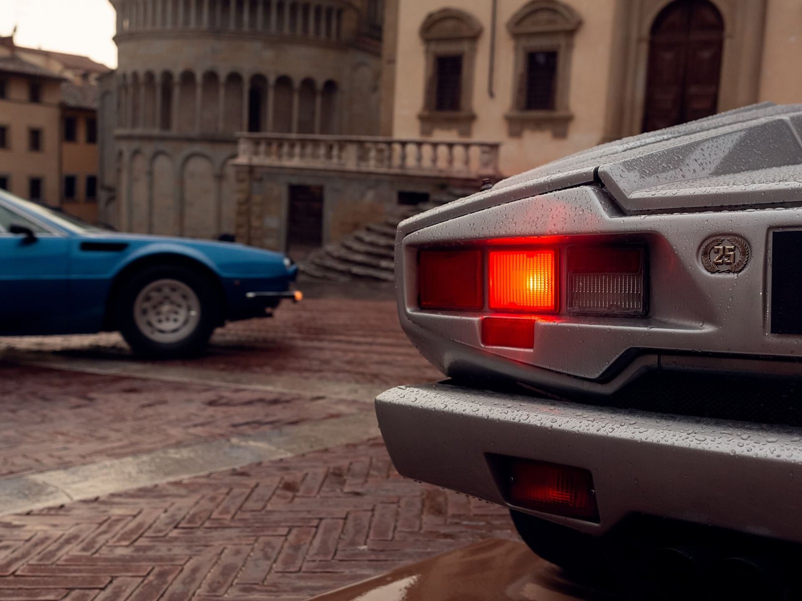Rear view of the silver Lamborghini Countach 25th Anniversary on wet cobblestones during the 2020 Modena Cento Ore rally