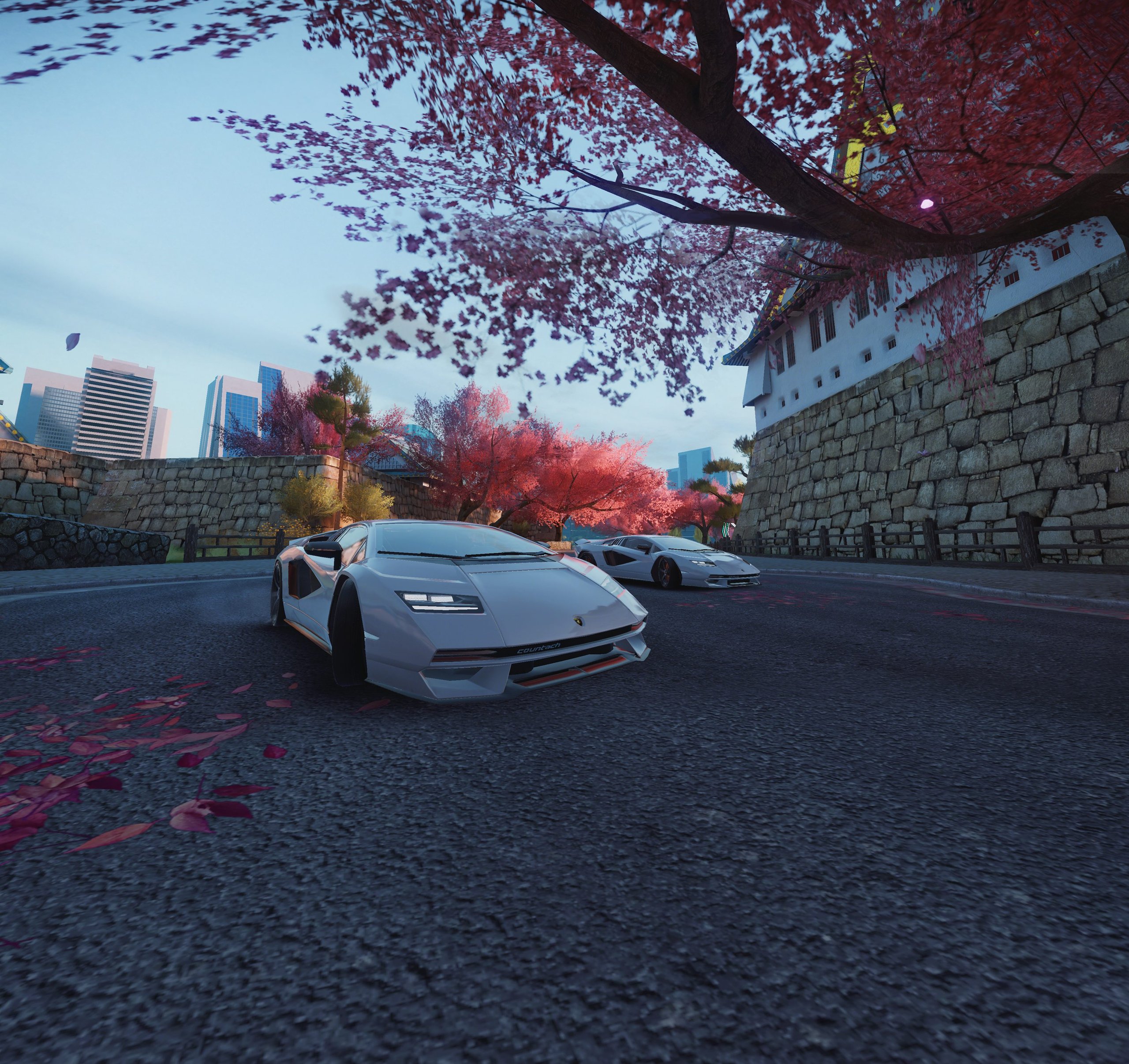 The Countach Lpi 800-4 Enters Asphalt 9: Legends, And Lamborghini Wants You To Race For It 7 White lamborghini countach lpi 800-4 driving under cherry blossom trees in asphalt 9: legends