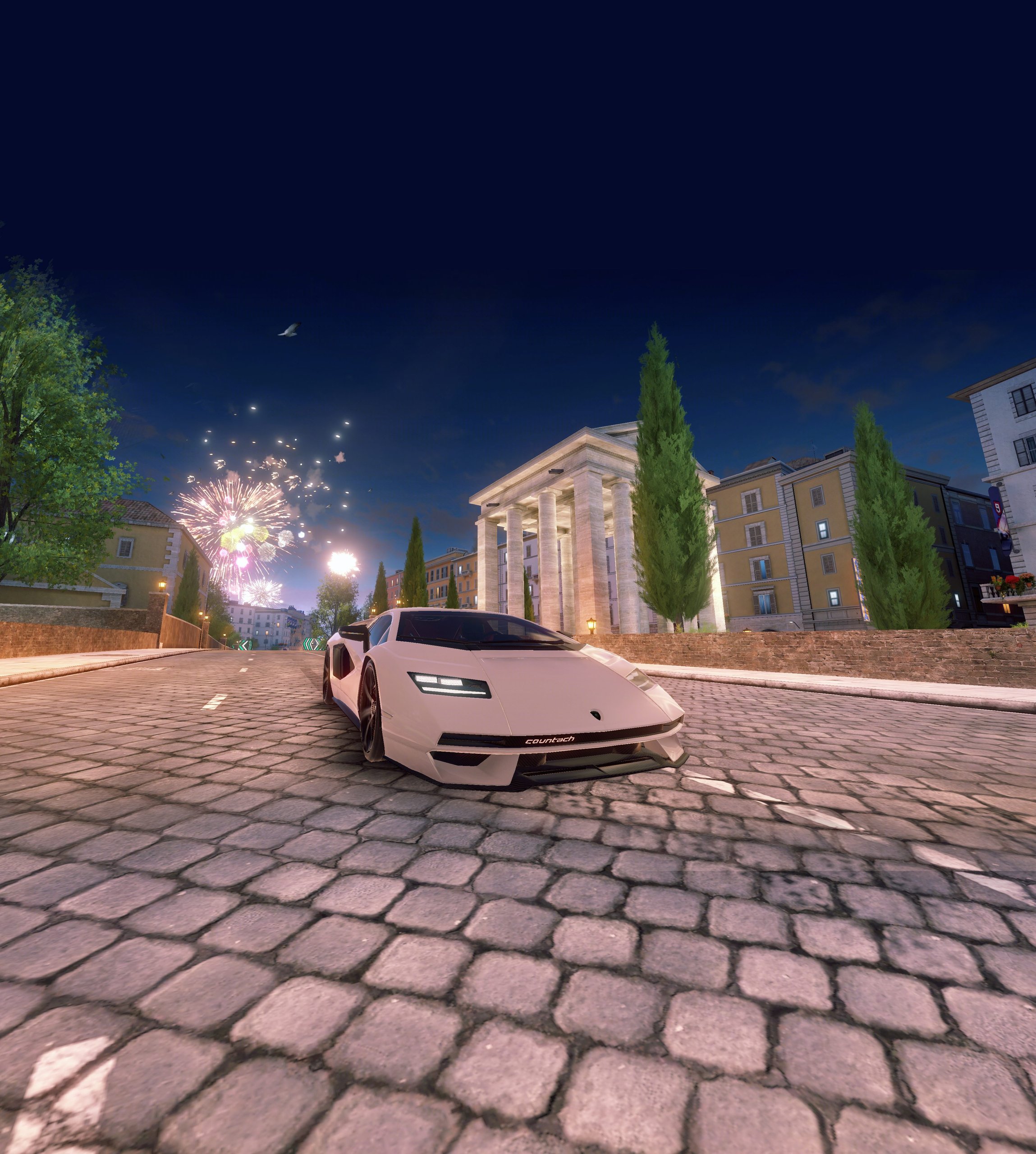 The Countach Lpi 800-4 Enters Asphalt 9: Legends, And Lamborghini Wants You To Race For It 9 White lamborghini countach lpi 800-4 driving on cobblestone at night with fireworks in asphalt 9: legends